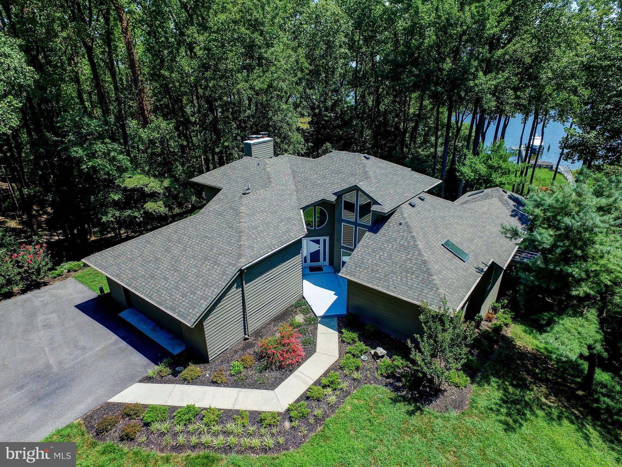 BOATER'S PARADISE !! Large waterfront home on over 2 acres on the Magothy River. FOURTEEN FOOT water depth at end of pier. Commercial grade pier with two slips and lifts - One will hold 60 ft at 80,000 lb / the other 40 ft at 60,000 lbs. Surrounded by agricultural and preserved properties. VERY PRIVATE. With over 5000 sq ft on three levels - this home has a fantastic wide open floorplan designed to take advantage of the spectacular water views from nearly every room. Tremendously solid construction. This is the perfect waterfront for anyone who enjoys boating or simply enjoying the relaxed waterfront lifestyle. Covered screened Porch/Meditation/Yoga Room off master bedroom .. enormous Master Bath with separate shower and soaking tub. Possible 5th bedroom. Numerous decks and plentiful built-ins throughout. Move in ready - or add your own personal touches. Two car garage parking, storage shed, "dog house", and Screened gazebo and sun deck located on the pier. This is what waterfront living is supposed to look like.