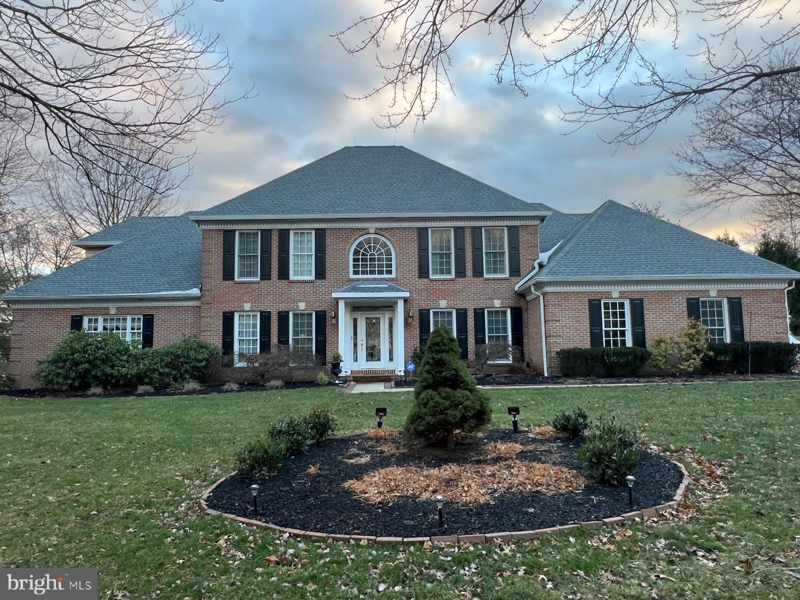 Exquisite 4,845 square foot brick executive style home nestled on a 1.24 acre corner lot in a quiet neighborhood in Jericho Valley in the award winning Council Rock School District! Built in 2006 and located in the heart of Historic Bucks County, this property features 5 bedrooms with TWO master suites, one on the main floor and one on the 2nd level. Enter the two-story foyer through the glass front door with dual side light panels and transom. The foyer is flanked on the left by a formal living room which is currently being used as a home office and on the right by an oversized formal dining room.  A center hallway leads to the great room with vaulted ceilings, floor to ceiling wood burning fireplace, wet bar and walls of windows bringing lots of natural light to the living area. The great room opens directly to the breakfast room and gourmet kitchen, which has sliding glass doors opening to the private deck in the back of the home. The first floor master bedroom with en-suite bathroom offers a large sitting room, walk-in closets & opens to a separate private deck in back. Perfect for an au pair or multi-generational living. The home has gorgeous wood floors, wainscoting and crown molding throughout with Dentil crown molding on first floor. The laundry room, pantry, coffee bar and powder room complete the main level. Upstairs is a second master suite with large en-suite bathroom and extensive walk in closet space. The second level features three other bedrooms, one with a sitting room, and a Jack & Jill full bathroom.  Ascend to the finished lower level featuring a gorgeous wet bar with TV, a regulation, slate pool table, media space and a very large storage room. Outside are 1.24 pristine acres with two decks, a storage shed, professional landscaping and a three car garage. New roof with LeafGuard gutters, new heater, and a Generac whole house generator complete this luxury estate home. Easy commutes to all major highways and train stations to NJ, NYC & Philadelphia.