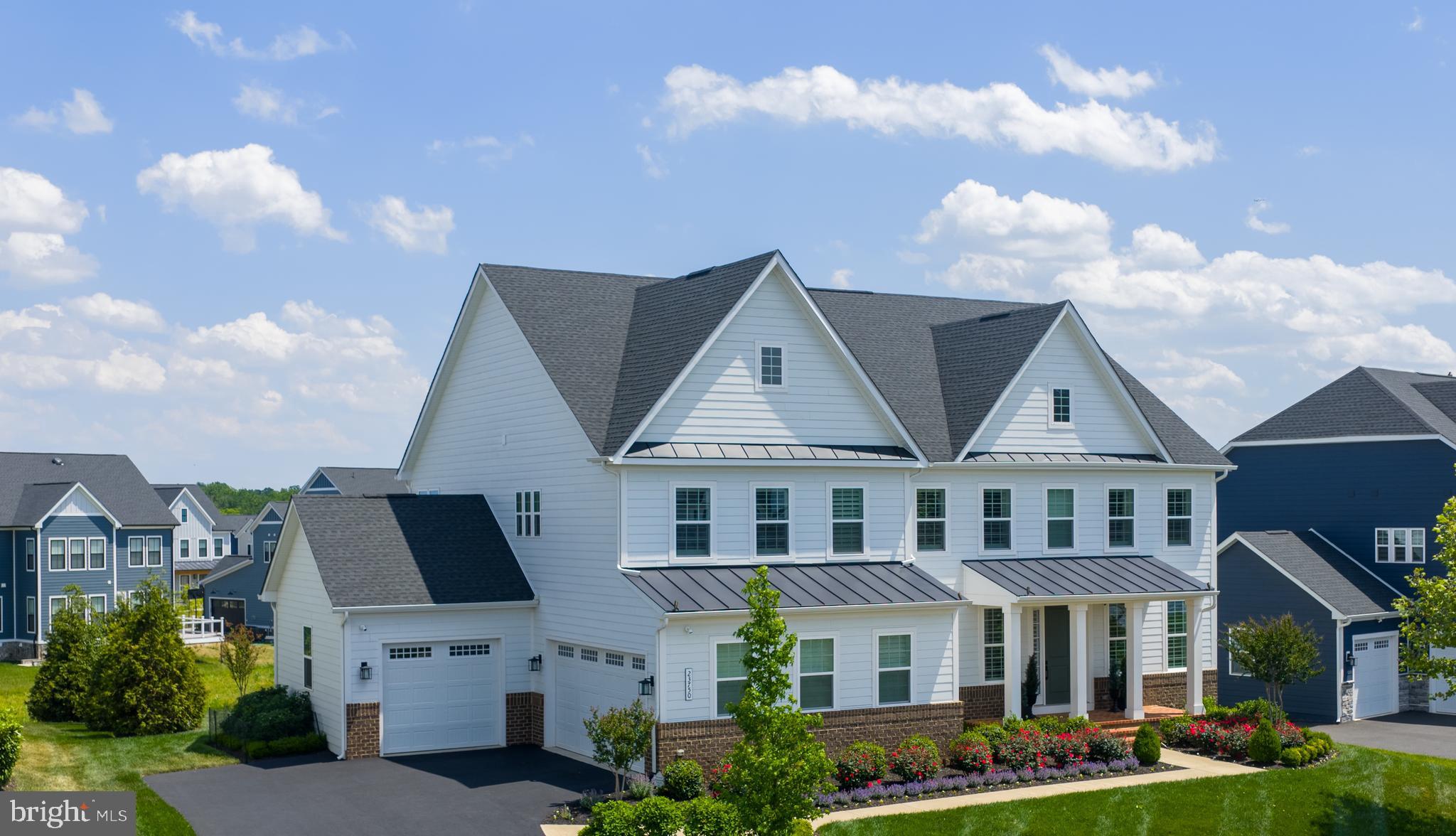 Featuring a first-floor bedroom suite, welcome to 23750 Great Bend Lane; a stunning single-family home in the highly sought-after Hartland, one of Aldie, Virginia (20105) and the greater Stone Ridge area’s most desirable luxury communities. Inside and out, this meticulously maintained home features high-end upgrades already completed, the luxury lifestyle is waiting, and everything is move-in ready to be fully enjoyed from day one.

Mornings begin with natural light pouring into the kitchen, relaxing on the stone patio surrounded by professionally established landscaping, and quiet walks through the neighborhood trails. Weekends offer a resort-style experience with afternoons at Old Farm Winery, located right within the community, time by the Hartland pool and clubhouse, fitness center, tennis matches, playground visits, or evenings entertaining with friends as indoor and outdoor living flow seamlessly together.

The sought-after first-floor bedroom suite (main-level bedroom) offers exceptional flexibility for multigenerational living, guests, or a quiet work-from-home retreat; while every additional upper-level bedroom functions as its own private suite complete with a full bath and walk-in closet. The result is a floor plan that creates comfort, flexibility, and privacy throughout the home.

Inside, this expansive NVHomes Stratford Hall model offers over 6,100 square feet designed for experience. At the center of it all is a kitchen anchored by high-end appliances including a Sub-Zero refrigerator and wine fridge, Wolf range, Wolf double ovens, an additional third oven, quartz countertops, and a farmhouse sink. The space flows into a dramatic two-story great room with generous gathering spaces, and a layout that naturally brings people together. The result is a highly functional floor plan that lives beautifully for both private routines and larger gatherings.

The upper level culminates in a magnificent primary suite designed as a true sanctuary. A private sitting area offers a quiet space to unwind, while the spa-like primary bath features dual opposing vanities to ensure completely separate, personalized space. The experience is completed by a massive walk-in closet equipped with a high-end custom closet system, offering effortless organization.
The finished walk-out lower level, over 1,850 finished square feet, including a full bath adds exceptional flexibility for entertaining, recreation, guest overflow, or additional living space. It serves as a flexible blank canvas; perfect for a home theater, private gym, or ultimate game room. The lower level is completed by an expansive unfinished space, offering incredible, easily accessible storage solutions.

This is the rare opportunity to own a custom finished luxury home ready for immediate enjoyment in one of Loudoun County’s most desirable communities. Beyond aesthetics, the home offers the practical luxury buyers appreciate most with a Tesla car charger, enhanced Wifi, wireless controlled irrigation, custom exterior lighting, remote access home controls, including the security system with exterior cameras. All with the peace of mind that comes with a home that has been lightly lived in and meticulously maintained.

This NVHomes Stratford Hall home at 23750 Great Bend Lane, surrounded by Hartland amenities, is just minutes from Brambleton Town Center, StoneSprings Hospital Center, and with convenient commuter access to Route 50. This Aldie home offers the exact balance many Northern Virginia buyers hope to find: modern luxury without the wait, projects, or compromises. Here, the details have already been elevated, the spaces already completed, and the lifestyle already established.

Everything buyers usually spend months upgrading after closing has already been beautifully completed.