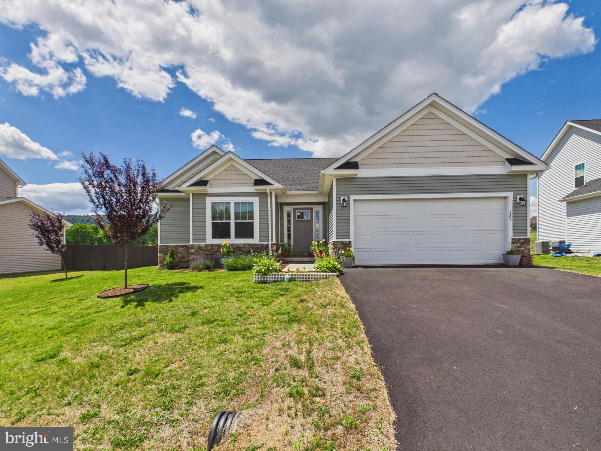 Welcome to this nearly new rancher-style home, built in 2022 and meticulously maintained. This home offers the feel and condition of new construction without the wait.

Inside, you'll find 3 spacious bedrooms and 2 full bathrooms, along with engineered hardwood flooring throughout the main living areas and plush carpet in the bedrooms for added comfort. The open-concept design features a vaulted ceiling that enhances the spaciousness of the living room and kitchen, creating an inviting space for both everyday living and entertaining.

The kitchen is the heart of the home, complete with a large center island, pantry, and ample cabinet and countertop space. Just off the kitchen, a dining room bump-out provides additional room for gatherings and everyday meals.

Step outside to enjoy the brand-new TREX deck overlooking the backyard—perfect for relaxing, grilling, or hosting family and friends. Additional features include an attached two-car garage and modern finishes throughout.

If you've been searching for a move-in ready home that combines the benefits of newer construction with exceptional care and minimal wear, this property deserves a spot at the top of your list.