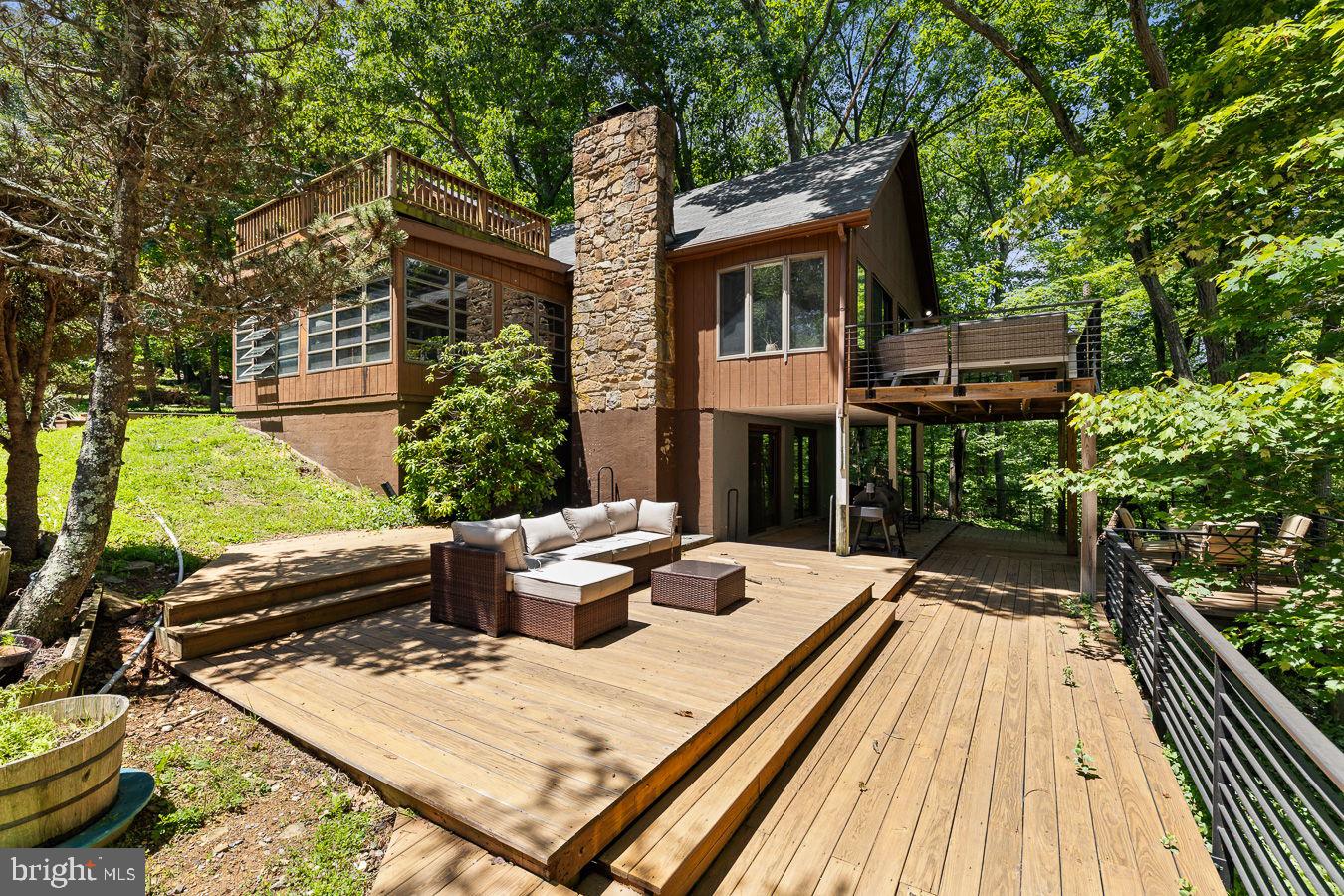 Welcome home to this stunning property at 274 Three Oaks Dr! Serving as the perfect retreat from the everyday hustle, this magnificent estate is situated on an expansive, fully enclosed 5 acre lot in the wonderful Autumn Hills Estates community, which offers a year round creek with a walking path, gazebo, and look out area. This property features a main residence and a fantastic guest house, where the lower level is currently used as a spacious workshop complete with heat, a half bath, and its own private deck. Outdoor living is unmatched here, featuring an in ground pool with concrete decking for hot summer days, a small fish pond with a tranquil water feature, and several large decks and sitting areas perfect for entertaining and enjoying your private trails. Inside, the main home perfectly blends modern design with ultimate comfort, boasting a gorgeous, updated kitchen equipped with plenty of workspace for the home chef. Fresh, modern flooring spans the living spaces, creating a seamless and sophisticated look, while the beautifully updated bathrooms showcase stylish fixtures and contemporary design. For added convenience, the home also features a newer washer and dryer setup. Stay fully connected with excellent internet options including satellite services via Starlink, Hughes, ViaSat, or AllPoints Broadband. While you will feel a world away in your private oasis, you are still just a short drive to premier dining, shopping, and major commuter routes. Beautifully renovated, uniquely private, and perfectly located, this rare retreat won't last long!