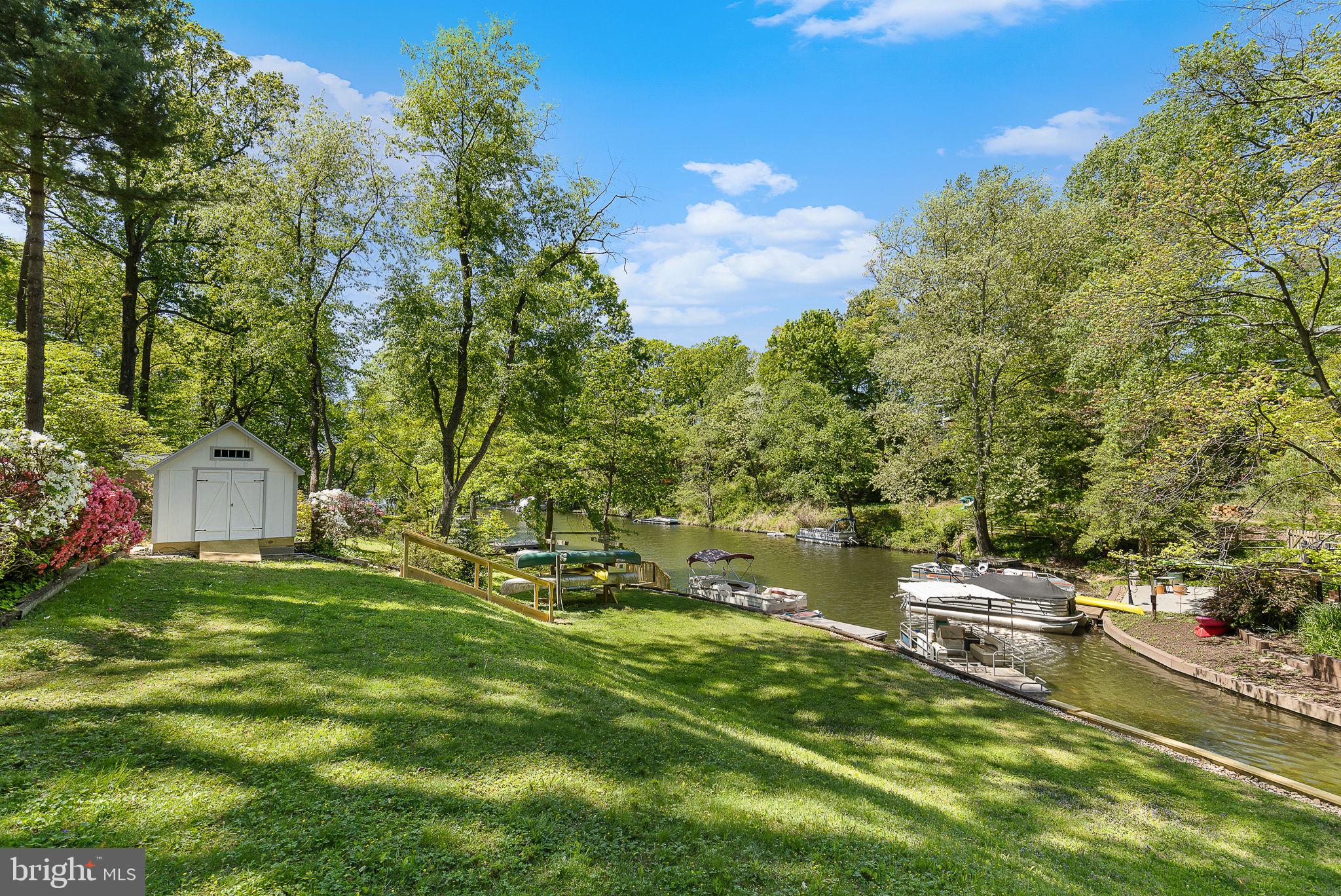NEW PRICE! Lake Barcroft – Exceptional Lakefront Living! Tucked away on a quiet cul-de-sac, this expansive home offers over 100 feet of gorgeous lakefront and stunning water views. The split-level offers plenty of room to spread out, entertain, and enjoy the scenery. Features newer windows throughout and hardwood floors on the main level. The expanded eat-in kitchen boasts top-of-the-line stainless steel appliances and a breakfast bar. Sliding doors in the breakfast area open to a Trex deck overlooking the lake and landscaped backyard.  The main level also includes a sun-filled dining room with a bay window and a welcoming living room with a gas fireplace. Upstairs, you'll find four additional bedrooms and two full baths, including an en suite primary with peaceful lake views.  The lower levels offer two more bedrooms, a full bath, and a laundry room. The expansive recreation room includes new plush carpeting, a gas fireplace, and space for a game/pool table. French doors open to the backyard, and another door leads to a workshop and the slate patio. Outside, the beautifully landscaped yard is a private retreat with a strolling path to the water’s edge and multiple outdoor living areas. Don’t miss the spacious new boathouse—complete with electricity!  A 1-car carport adds everyday convenience, and a brand-new roof provides peace of mind. Enjoy all the perks of Lake Barcroft living—boating, swimming, fishing, and five sandy beaches—plus a close-knit community and year-round events.  With easy access to commuter routes (50/66/495/395) and just a short drive to DC, Arlington, and Tyson's, this home has it all!