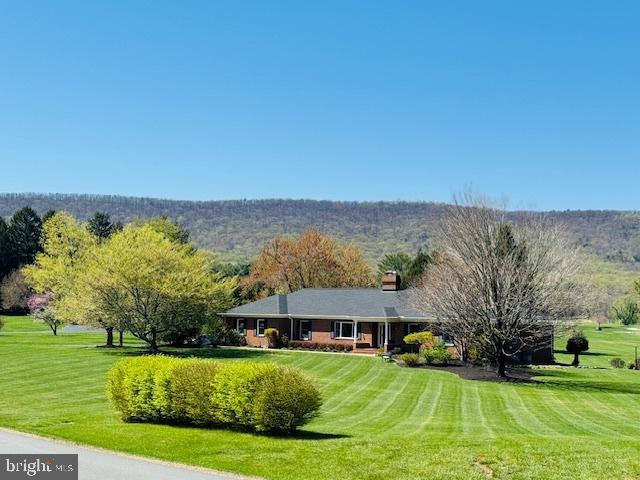Nestled next to the gates of Evergreen Country Club and the historic boutique hotel The Inn at Evergreen, this one of a kind main-level living home on a premium 2.37 acre lot is the gem of the sought after community that is Evergreen Farm. The welcoming exterior features a long driveway leading to a 2 car side load garage plus golf cart parking, impeccable landscaping along a walk-way to a covered front porch ready for countless hours of relaxation while rocking your worries away and watching nature pass by.  NEW 50 year roof(2023), NEW attic insulation and radiant barrier, Newer gas boiler for radiant heat, top of the line water softener/filtration system and newer septic tank(2018) all for worry less living. With over 4200 finished square feet on 2 levels, the open concept interior is an environment of refined authenticity and elegance with durable hardwood floors; crown and chair moldings; plenty of recessed lighting; upgraded light fixtures and ceiling fans; and a neutral color palette throughout ready for your personal touches. The gourmet kitchen is a chef's dream, boasting stainless steel Wolf appliances to include the gas cooktop; copper sink; island and bar; granite countertops; recessed under cabinet lighting; backsplash; custom pantry with stealth black board door; and opens to a large entertaining room with custom tray ceiling and wall to wall windows ready for game night or a cozy night in next to the fireplace while taking in the spectacular views of the golf course and Bull Run Mountain.  The luxurious primary suite is the perfect retreat, with a large en suite bath and private entrance to one of the bedrooms perfect for a nursery or office. Three additional generous bedrooms, full bathroom, a formal living and dining room as well as a large mudroom complete the main level. The finished walk up basement has a sprawling rec room with a fireplace and wet bar, flex room for gym or teen space, a spa-like full bathroom ready for a sauna and offers plenty of storage or endless options for more finished private or shared living spaces. Spend countless weekends entertaining or just relaxing on the newly stained deck with built-in grill and steps down to an impressive stone patio and flat backyard with majestic golf course and mountain views.  
 In-ground dog fence for your four legged family members.  Minutes to groceries, restaurants, parks, and everything Haymarket/Gainesville have to offer. Don’t Miss Out!