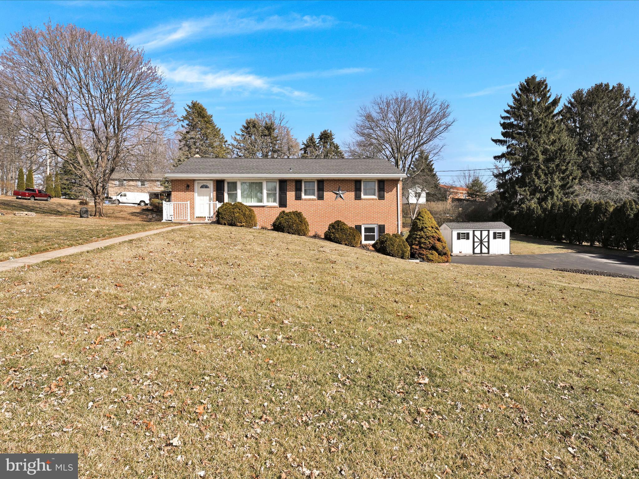 Welcome Home! This solid 3 BR, 2 BA brick rancher in popular Dallastown School District is waiting to be made yours! This home features an oversized 2-car garage, partially covered patio area with privacy fencing, newer Andersen windows, newer roof, boiler, water heater and Generex Generator. The living room has a bay window with custom window treatments that overlooks the front yard. The kitchen/dining area feature gas cooking, open to a private patio and include all appliances. Ceiling fans are in all the bedrooms and both bathrooms have had some updates. The finished lower level has a wood burning fireplace with a brick surround. The laundry/utility room include the washer and dryer.  Outside you have plenty of yard and a shed for storage. Plenty of parking. Amazing location near shopping, schools and parks! Available for showings March 1st!