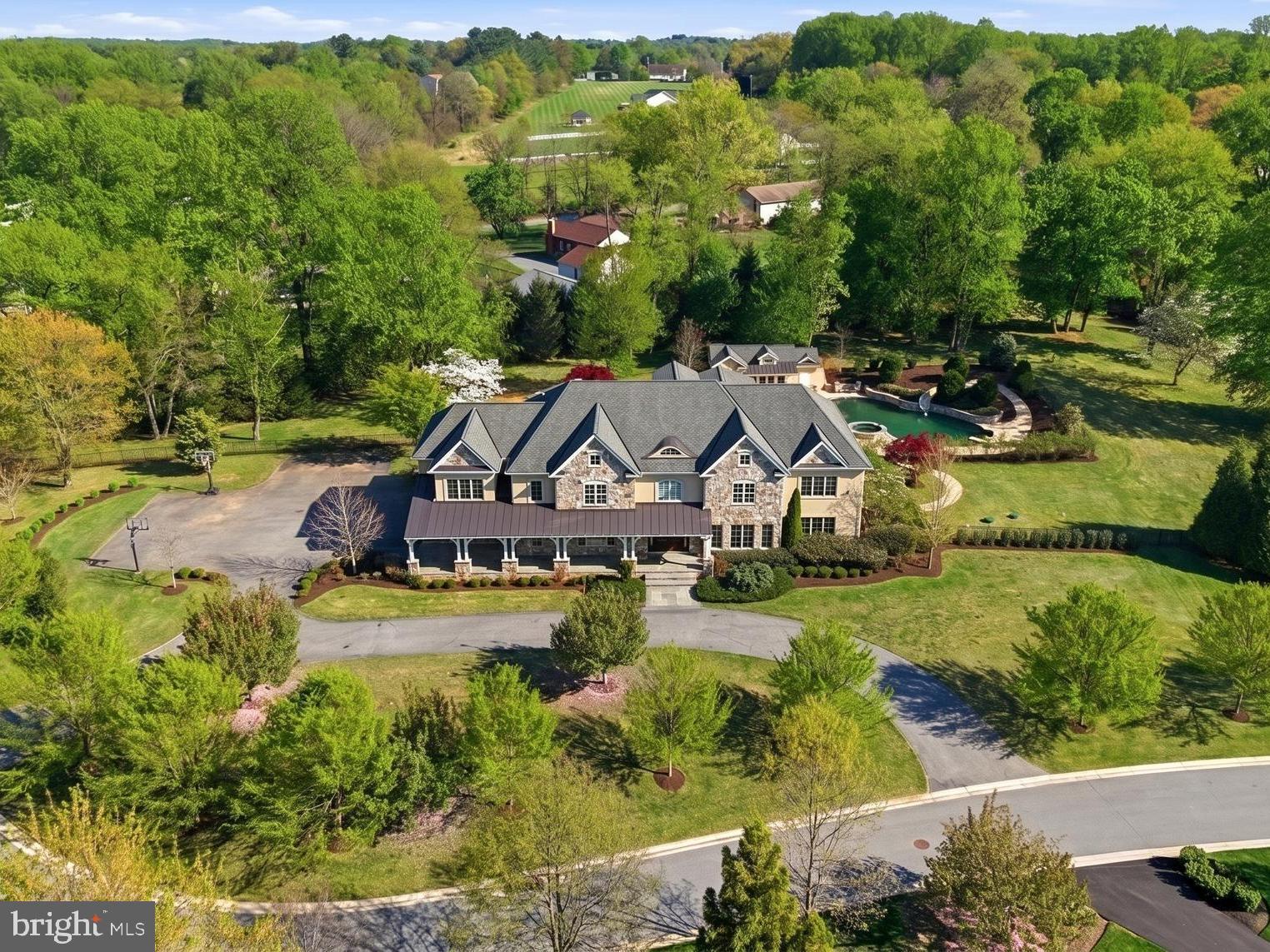 * * PRIVATE CUL-DE-SAC * * DOUBLE LOT * * RESORT-STYLE BACKYARD * * SCHEDULE YOUR PRIVATE TOUR TODAY * *
Positioned at the end of a quiet cul-de-sac on a rare double lot, 12228 Worthington Rd is one of the most significant residential offerings in the community, delivering over 12,000 square feet of refined living space and making its debut on the open market. From the moment you arrive, the scale and presence are undeniable. A grand double foyer with soaring ceilings opens into a sweeping double great room, anchored by a dramatic spiral staircase that immediately defines the home’s architectural statement.

Designed for both everyday living and elevated entertaining, the main level offers a seamless, thoughtfully curated layout. Highlights include a private office, a main-level junior suite ideal for guests or multigenerational living, and dual sunrooms that flood the home with natural light. Every space is intentional, balancing openness with warmth and functionality.

Upstairs, the home continues to deliver with large bedrooms, each one larger than the last, and en-suite bathrooms, along with a third-story loft that adds flexibility for additional living, work, or creative space.

The lower level transforms into a true private retreat. A full resort-style experience featuring a custom bar, dedicated home theater, private gym, and expansive recreation areas designed to adapt to any lifestyle.

Outside, the property reaches another level. The fully fenced grounds provide rare privacy, anchored by a pool with its own dedicated pool house, an outdoor kitchen, fireplace, and multiple curated seating areas. Whether hosting large gatherings or enjoying quiet evenings, the setting is built to deliver. An extended driveway accommodates 15–20 vehicles, a rare and valuable feature for a home of this scale.

Opportunities like this are few and far between. Schedule your private showing today.