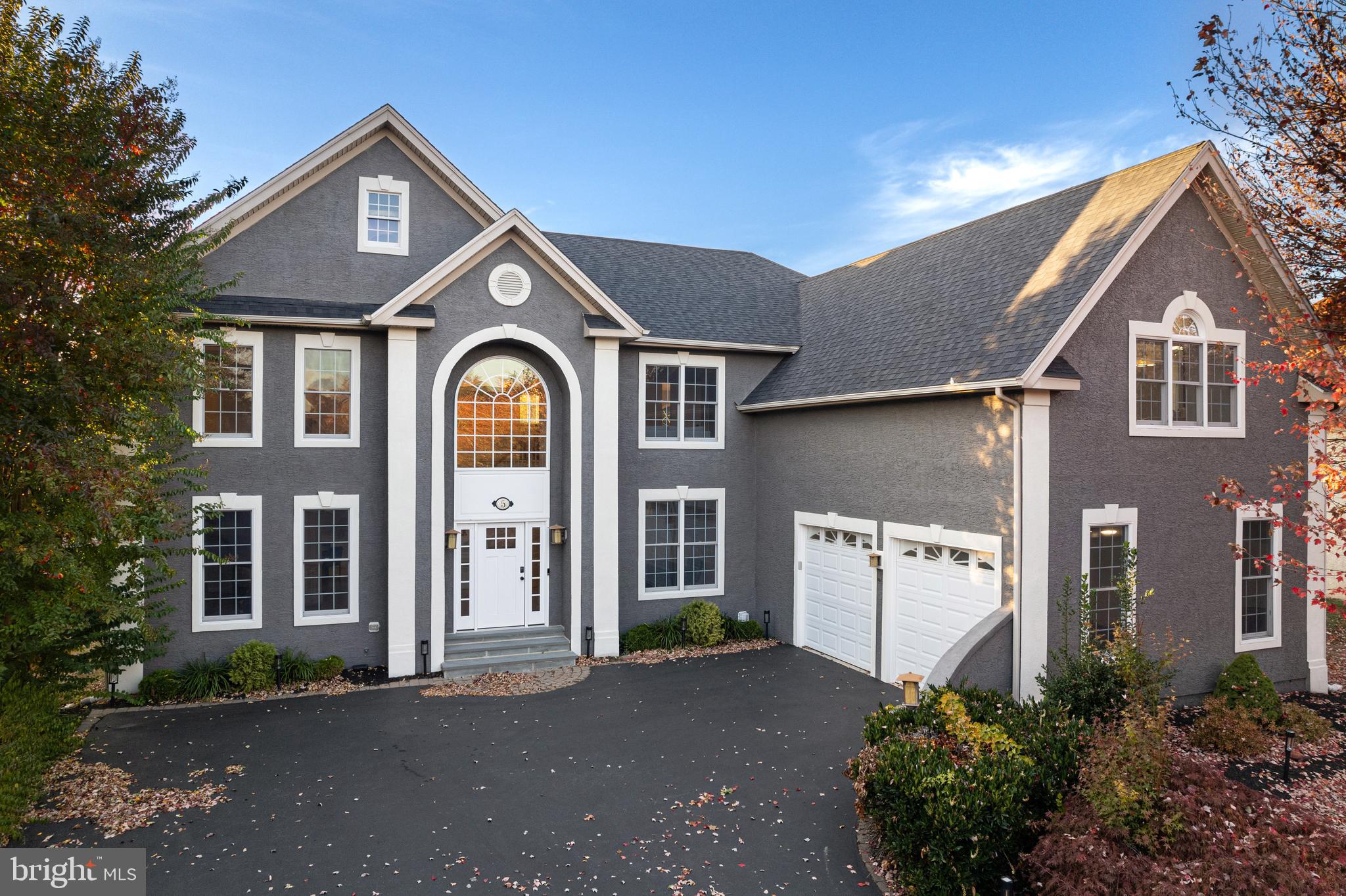 Welcome to 5 Barn Owl Court, an updated luxury estate home within the Rivercrest Golf Community of Upper Providence. This home has been thoughtfully redesigned to blend elegance with modern functionality. Step inside to find a freshly painted interior with designer light fixtures and custom window treatments. The gourmet kitchen features new high-end appliances, cabinetry, granite countertops, and a sunlit breakfast nook. The kitchen flows into a two-story family room with a wall of windows showcasing serene views and access to a composite deck—perfect for entertaining. The main level features an in-law suite complete with a full bath, making it ideal for guests or multi-generational living. Upstairs, the primary suite is a private retreat with dual closets, a cozy sitting area, and a spa-like bathroom. Spacious secondary bedrooms include en-suite bathrooms and custom closets. The newly finished, walk-out basement offers a flexible space for a media room, gym, or game area with access to a hard-scaped patio. Smart locks, a new premium HVAC system, and custom closets add to this home’s convenience. Rivercrest offers a private golf course, resort-style pool, scenic walking trails, and a clubhouse with dining and fitness facilities, all within the top-rated Spring-Ford School District. Schedule your private tour today to experience the lifestyle this home offers!
