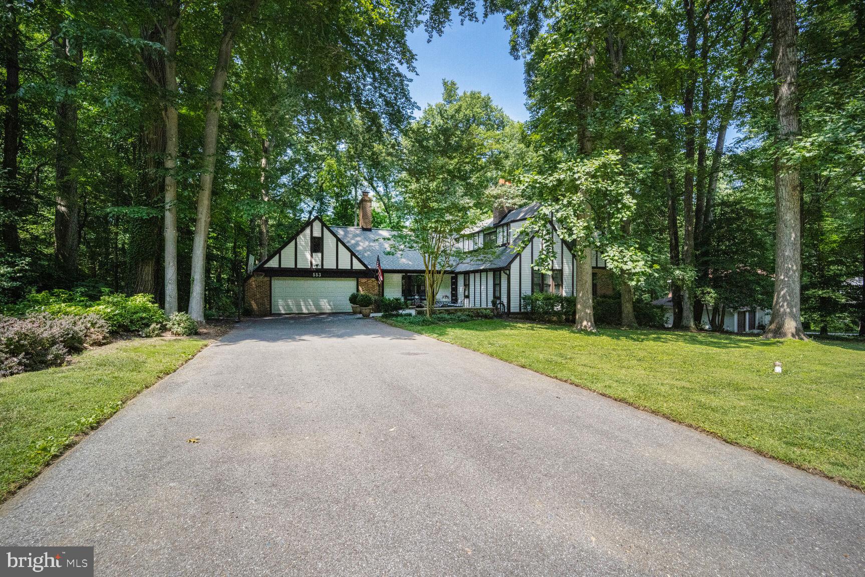 Tax records are incorrect the house has over 3500 square feet of finished living space.
English Tudor featuring large slate patio, flagstone retaining wall and small covered front porch, surrounded by mature trees and extensive landscaping. HVAC 2 zone system replaced with high efficiency units in 2021 & 2022.  Driveway repaved and expanded in 2020. Great room with cathedral beamed ceiling, wide blank redwood walls, floor to ceiling brick fireplace, and Andersen slider to deck.  Oversized 2 car garage with floored attic above for future expansion. Drywell was replaced and expanded in 2015. Exterior trim boards replaced in 2024.  Rear deck is 45ft.x16ft. built to hold a large hot tub and perfect for large gathering.  Back yard is level with ample play area and room for a pool, overlooks wooded community open space.  
Spacious living room with hardwood floors and brick fireplace.  Gourmet kitchen features solid cherry cabinets, stainless steel upgraded appliance package and large kitchen island with quartz top.
First floor guest room with wood floors and large closet with shelving.Three of the four bathrooms have been renovated. Lower level has large clubroom, office/study and full bath with walk-in shower. Large storage room with built-in storage. Community has water access to Saltworks Creek with fishing pier & dock for canoes and Kayaks. Convenient location for community to DC or Baltimore, 20 minutes to BWI Airport and five miles to Annapolis historic District and Naval Academy.