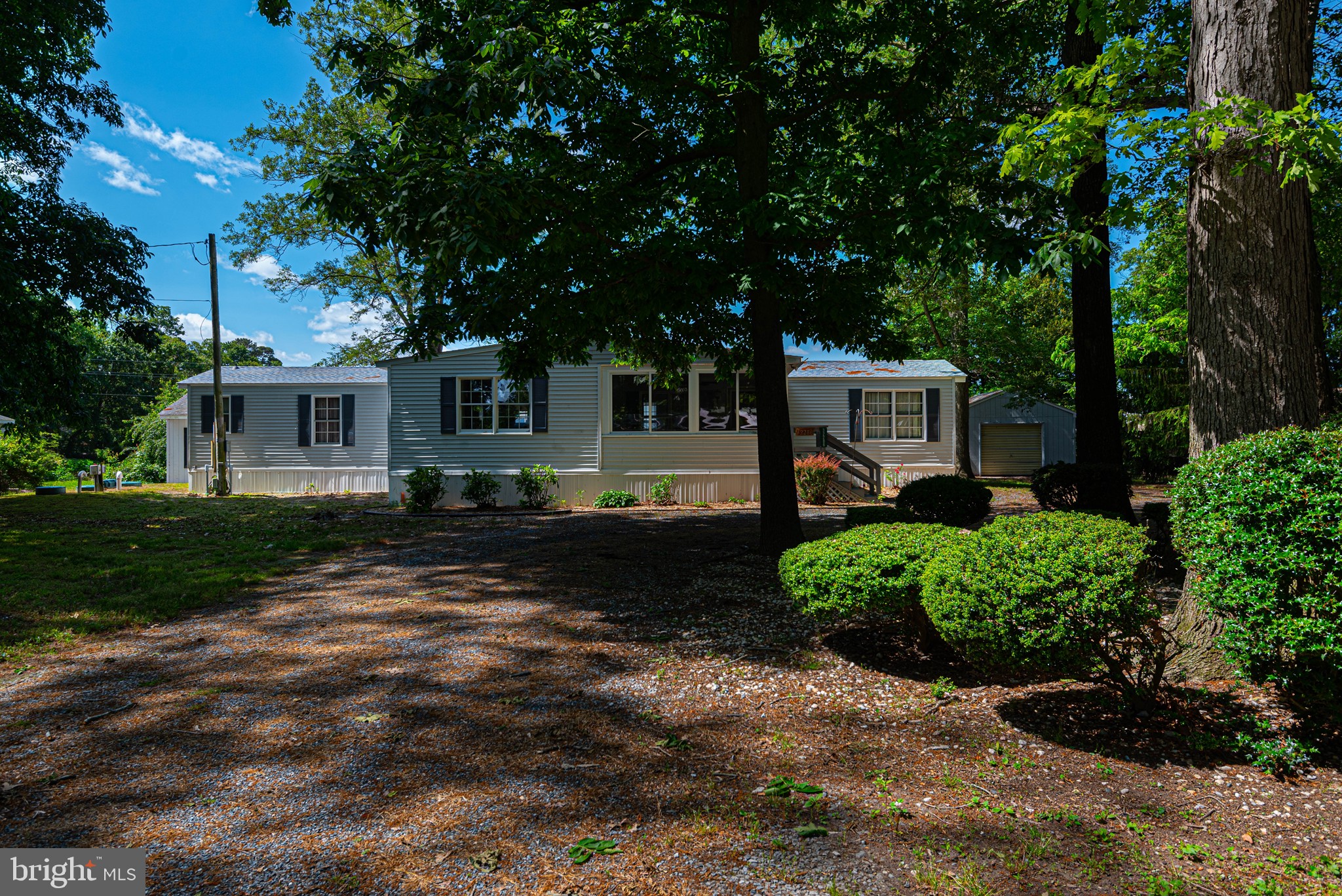 NEW PRICE $250K!  INCOME PRODUCING PROPERTY!  This property has 2 homes!  A single wide home with 2 additions for added square footage, 2 bedrooms and 2 baths AND a cottage with 1 bedroom and 1 bath.  Located in the community of Dogwood Acres with access to the bay and a LOW HOA! The 14x70 1987 Oakwood Mobile Home was purchased brand new!  Lived in by one owner this home has 2 bedrooms and 2 full baths.  A 15x15 living room addition was added along with a 14x15 3 season room on the front and 15x12 screened porch on the back. The cottage is 18x24 and offers a full kitchen, 1 bedroom and a 1 full bath. There is a 16x16 detached one car garage to the right.  A fully fenced in back yard is great for your pets! Low HOA is $50.00 voluntary per year. The community offers water access via the boat ramp and a small beach.  Boat slips may be available to rent.  There is a near by marina for larger boats.  Short drive to the to the beaches, shopping and hospitals. Septic replaced in 2014 - McMullen Septic - septic has been inspected and passed Roof replaced on mobile in 2022 Heat Pump - maintained with service agreement / Blades HVAC - last serviced 2021  UPDATE:  New bedroom floor installed 10/2025. 
**AGENTS:  Please read agent remarks.