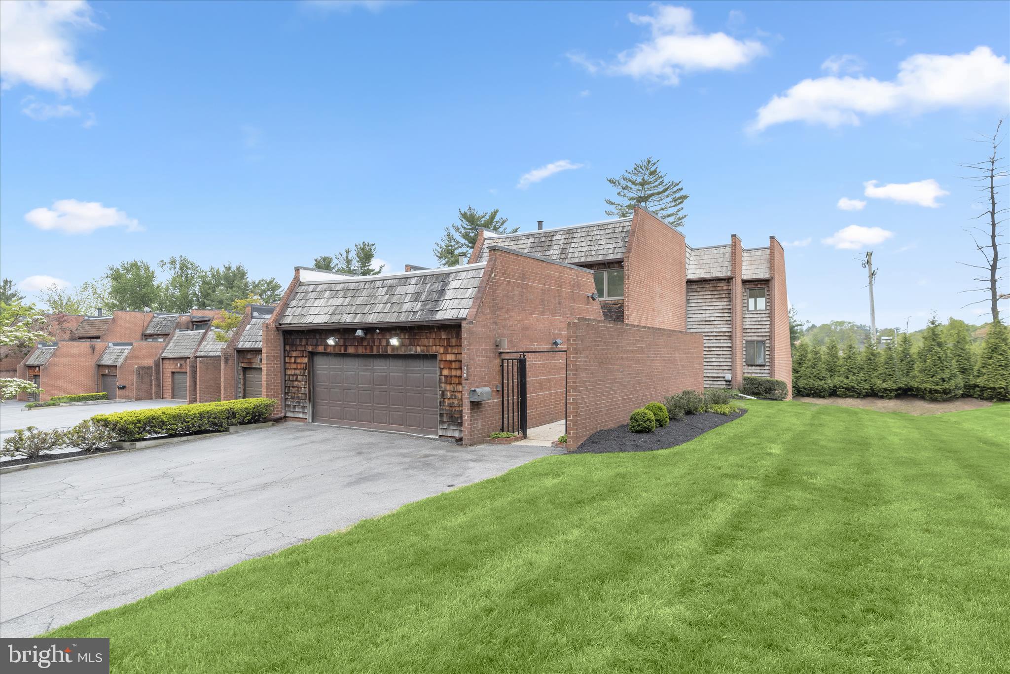 Introducing this charming six bedroom, three and a half bathroom end-unit townhome in the sought-after Stevenson Crossing neighborhood. Offering over 3,800 square feet of beautifully designed living space across three levels, this sun-filled home is one of the largest in the entire community. As you arrive, a gated front courtyard provides privacy and access to the attached two-car garage. Step inside to discover rich hardwood floors and abundant natural light throughout the main level. The inviting living room offers a cozy retreat with a large skylight. Prepare your favorite meals in the updated kitchen that boasts quartz countertops, a tile backsplash, soft-close shaker cabinets, a breakfast bar, and pantry. Stainless steel appliances include an electric range, double wall ovens, built-in microwave, refrigerator/freezer, and two dishwashers for added convenience. Just beyond, the elegant dining room accommodates gatherings of any size and is highlighted by wainscoting, a statement chandelier, and sliding wood pocket doors leading to the impressive family room. Anchored by a wood-burning fireplace, floor-to-ceiling windows, and sliding glass doors, the family room serves as a peaceful retreat. Outside, the rear deck provides the perfect space for lounging or dining al fresco. The main level also includes a bedroom ideal for an office or den, along with a half bathroom down the hall. Upstairs, the primary bedroom suite features a large walk-in closet and a luxurious updated bathroom with a dual-sink vanity, frameless walk-in shower, and linen closet. Three additional bedrooms and a shared hall bathroom complete the upper level. Downstairs, the fully-finished lower level expands the living space with an expansive recreation room featuring sliding glass doors to the patio and rear yard. The sixth bedroom is located on this level, along with a third full bathroom and a versatile bonus room ideal for a gym, playroom, or additional office. A large laundry room with ample storage completes the lower level. Recent upgrades include replaced windows, zoned heating and cooling systems, a new roof, and more. Community amenities include a security gate, outdoor pool, playground, and basketball, tennis, and pickleball courts.