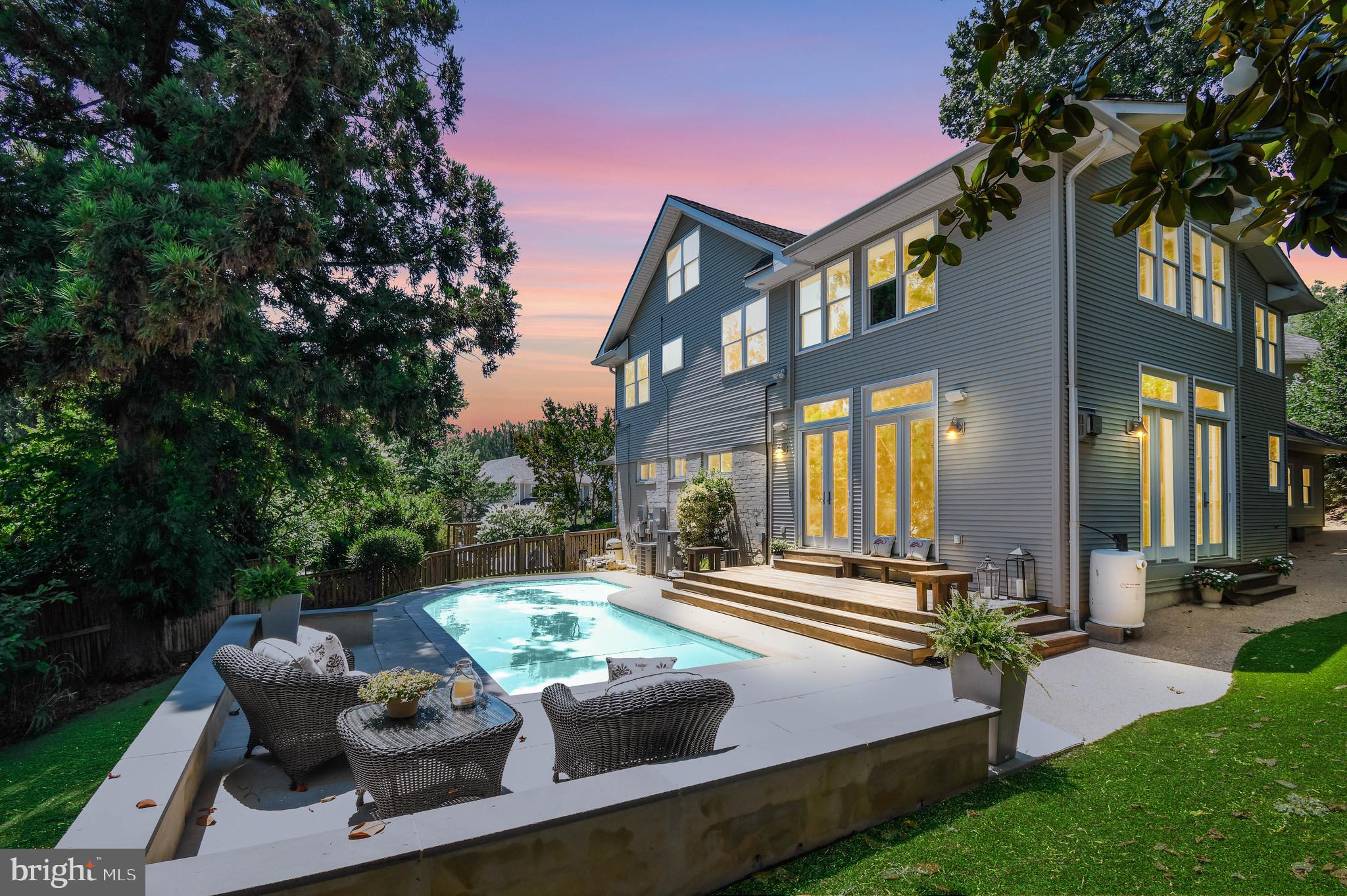 ***Offer Deadline *** Sunday 6/28 @ 6pm.  Welcome to this truly one-of-a-kind home tucked away on a quiet cul-de-sac in sought-after Minor Hill. Offering 5 bedrooms, 4 full bathrooms, a heated swimming pool, and an exceptional blend of character, space, and modern efficiency. This home is located within the Yorktown/Williamsburg/Discovery school pyramid.

Originally a 1950s ranch, the home was thoughtfully expanded both upward and outward in the early 2000s, by a previous owner, creating over three levels of versatile living space. Enjoy mornings on the inviting front porch overlooking the shared neighborhood green space, or arrive home to the convenience of a two-car garage. Energy-conscious buyers will appreciate the fully owned solar panel system installed in 2023, helping offset rising utility costs without the expense of a solar lease.

Inside, the original portion of the home features two main-level bedrooms, a fun black-and-white checkered full bath, and a welcoming living and dining area centered around a wood-burning fireplace with a stone surround. Continue through the home and prepare to be impressed by the expansive addition. Designed for entertaining and everyday living, the chef's kitchen boasts a professional-grade six-burner plus griddle gas range with double ovens, two sinks, two dishwashers(2025), an oversized refrigerator(2025), abundant cabinetry, and a wraparound breakfast bar.

The adjacent two-story great room is nothing short of spectacular, featuring a dramatic stone-front gas fireplace, extensive custom built-ins, rich wood trim, and two sets of French doors that seamlessly connect indoor and outdoor living. Step outside to a fully fenced backyard complete with low-maintenance turf(2023), a spacious wood deck, and a heated swimming pool—your own private retreat for relaxation and entertaining.

Upstairs, hardwood floors run throughout. This level has 3 bedrooms and 2 bathrooms along with  a convenient stackable washer and dryer.   The luxurious primary suite is a destination unto itself, offering a huge custom walk-in closet with a center island, pendant lighting, abundant natural light, a wall safe, and a keyed jewelry drawer. A wet bar leads to the primary bath featuring a dual-sink vanity, walk-in shower with body sprays, and a Jacuzzi tub. French doors open to an interior balcony overlooking the great room, creating the perfect sitting area or office.

Need even more space? A finished bonus room above the garage, accessible through a keyed door from the primary suite or via an exterior staircase, offers endless possibilities as a recreation room, office, fitness studio, or creative space. We aren't done with  the possibilites yet! Access the walk up attic from the primary suite. The large floored attic provides exceptional storage or future expansion potential.

The finished lower level adds even more flexibility with a recreation room, bonus room, laundry area, and fourth full bathroom.

Ideally situated between both East Falls Church and West Falls Church Metro stations and less than a mile from Williamsburg Shopping Center, this extraordinary property combines convenience, versatility, and distinctive style.