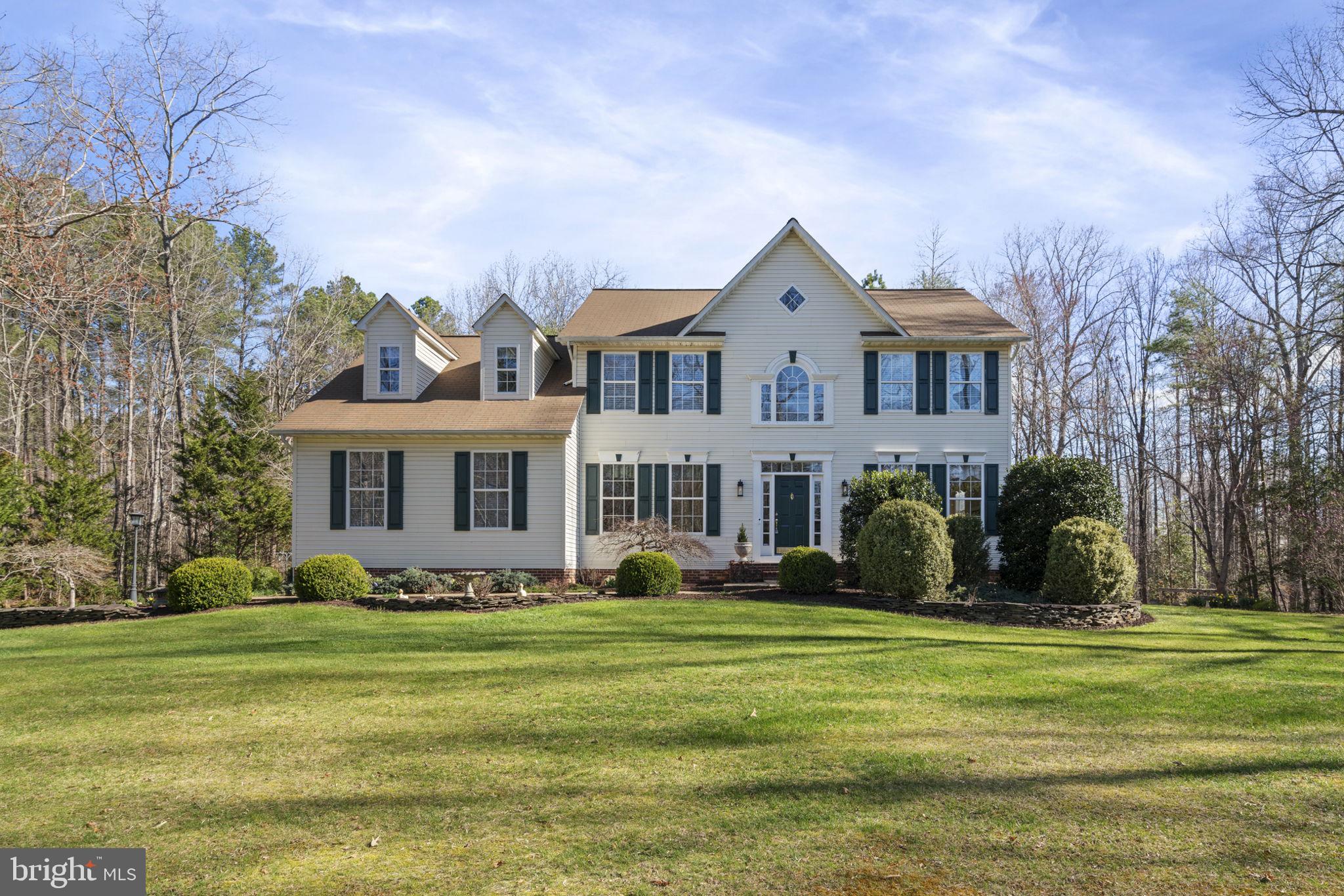 Stunning colonial situated on a quiet and serene 2 acre lot in Windsor Forest this home offers both community and seclusion.  Carefully maintained by the current owners, step into the 2 story foyer with a traditional, yet timeless, center hall colonial floor plan with hardwood flooring. A cozy office to the left of the main entry, with double glass doors, makes for the perfect work from home day. The formal living room to the right captures so much natural light it feels very much like a sunroom. Make your way to the formal dining room with space for a large table and gathering for friends and family. The kitchen features plenty of cabinet and counter space and stainless appliances, along with tiled flooring. Off the kitchen is a breakfast nook and a family room with vaulted ceiling, a gas fireplace and access to the spacious rear deck.  The deck overlooks a tranquil backyard featuring plants, an open grassy area, woods, a gold fish pond, and 2 stone patios, one patio off the deck and another patio off of the basement walkout level. Back inside on the main floor, don't miss the powder room and then the convenient laundry room off the garage. Upstairs you'll find 4 spacious bedrooms and a light and bright hall bathroom. A large primary suite complete with a reading/relaxation area, hardwood flooring, another gas fireplace, and an oversized walk in closet completes the upper level! The primary suite also has a large bathroom with dual vanities, tub, and separate shower. In the lower level you'll find a large open rec room with LVP flooring and a walk out entry to the stone paver patio. An abundance of natural light for a basement and many storage options in the lower level including a workshop space and rough in plumbing to easily add in another bathroom. Lots of open space to run around outside and the property also sits on a quiet street and cul de sac. The house comes with a side load 2 car garage and extra parking for 3 vehicles in the paved asphalt driveway. Don't miss this one!