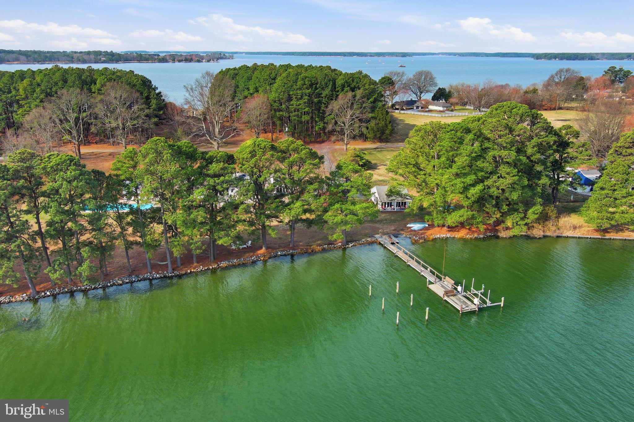 NEW PRICE DO NOT MISS THIS ONE
Nestled in the highly desirable Drum Point neighborhood of St. Michaels, this exceptional waterfront property offers the perfect blend of privacy, comfort, and Eastern Shore charm. Just minutes from the vibrant heart of town, you'll enjoy easy access to renowned restaurants, boutique shopping, cozy cafés, the Classic Motor Museum, and the Chesapeake Bay Maritime Museum.
A former successful vacation rental, this beautifully maintained three-bedroom brick home is designed for effortless living and year-round enjoyment. The open floor plan features rich wood flooring, a striking double-sided fireplace, a renovated kitchen, updated bathrooms, and energy-efficient geothermal HVAC.
Water views surround you at every turn. Relax in the shade of mature trees by the shoreline, sway in a hammock with refreshing bay breezes, or spend the day enjoying the property's outstanding outdoor amenities. Entertain guests on the spacious deck complete with an outdoor kitchen and hot tub, gather on the charming stone-walled patio, rinse off in the outdoor shower, and cool off with a swim in the pool.
Boaters will appreciate the private dock offering approximately 3 feet MLW, a boat lift, and a boat launch for easy access to the water. A detached two-room studio with a covered porch provides additional flexible space for guests, hobbies, or a private retreat while enjoying spectacular water views.
Additional highlights include an encapsulated crawl space and numerous upgrades throughout. This is Eastern Shore living at its finest—a rare opportunity to own a waterfront sanctuary in one of St. Michaels' most sought-after locations.T MICHAELS TUCKED AWAY ON DESIRABLE DRUM  POINT NEIGHBORHOOD, MINUTES FROM THE