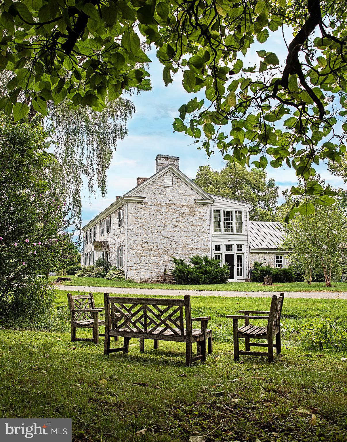 Major Price Reduction Lick Run Ca. 1774, 125 Acres, National Register of Historic Places. An Historic Stone Georgian 5000 sf home;  described on the Register Survey as  a substantial and very handsome house , and the surroundings as  excellent and unspoiled . Also included are a large limestone barn, a huge 4 level wonderful stone mill constituting a  Rare grouping of historic structures . The Home has 7 bedrooms, 5 fireplaces and two kitchens. In the recent past the floor plan has worked well for family compound or more than one family. The land has stunningly beautiful gently rolling grounds, with multiple streams, and a great WATERFALL beyond the mill for the millrace. The giant stone mill is served by this beautiful burbling mill race with an approximate 1 mile  walking path along it through the woods and fields. The house has renovated top of the line gourmet kitchen for the serious chef and beautiful master suite that opens to the upper porch and has peaceful views. There are two-tiered balustraded porch on the front of the house, providing pastoral views. They are perfect spots to breakfast,  relax, read, and enjoy the day. Floors are random width throughout. Lots of early hardware. The charming original log summer kitchen sports a large stone fire place, original floors and beamed ceilings. It is a perfect 18th century log room and provides great ambiance for friends and family dinners.  Tennis Court. Numerous outbuildings.  Yes, you can be convenient and getaway from the stress/ Convenient to nearby 1-81 and easily accessible shopping  centers,  about 5 miles to MARC commuter rain to DC.  Lots of possibilities  with this unrestricted, enchantingly beautiful property. PLEASE NOTE.  Two tax parcels: 109.99 acres and Lot 1 16.75 Acres .