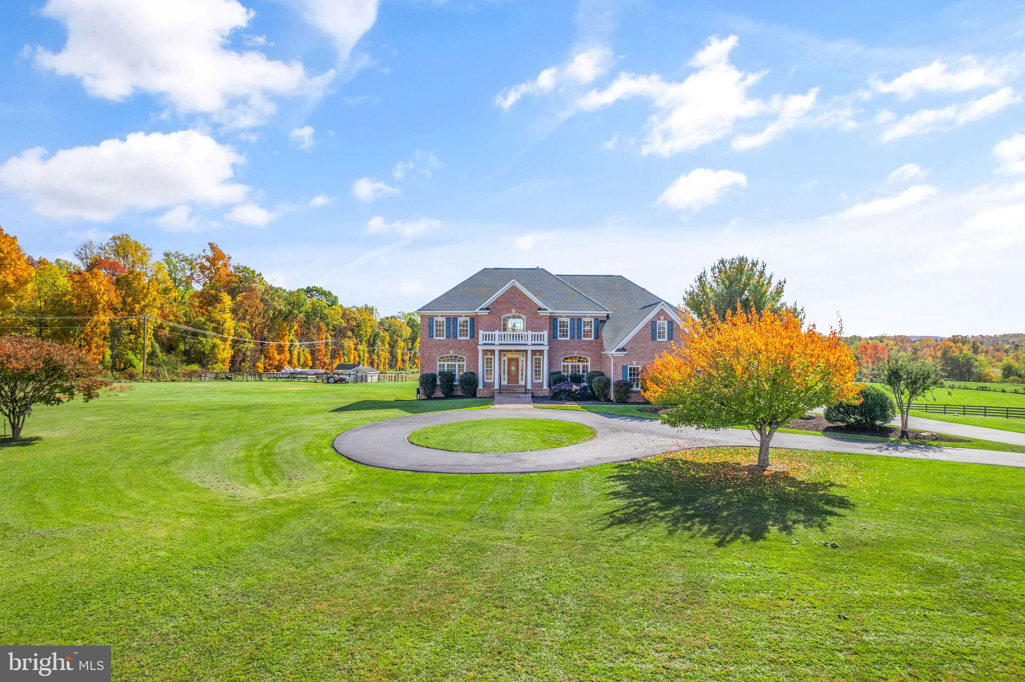 Spectacular 8,620 sq/ft custom home on 10 acres overlooking surrounding farmland
and with breathtaking mountain views. Conveniently located just 7 miles from
Leesburg shops and restaurants, 25 minutes from Dulles International Airport,  located in the heart of Loudoun wine country. No HOA or restrictions. <br><br>

Gorgeous custom design and meticulous owner attention to detail sets this home apart. The
house is endowed throughout with elegant and custom crafted features such as crown
molding, wainscoting, chair rail, tray and coffered ceilings. <br><br>

Both an entertainer's and a family's dream home, the main floor has a large dining and
living room, and three cozy fireplaces ideal for family and friend gatherings. A large
chefs kitchen has all the luxuries for fine cooking and dining including a gas 6 burner chefs
range and commercial hood, double wall ovens, 2 dishwashers and an oversized refrigerator, as well as a sun filled adjoining breakfast room. <br><br>

Immediately noticed upon entering the main floor is the abundance of natural light  and a rear 3rd staircase to the upper level. The family room stands out with coffered ceilings  and built in custom wall cabinetry. <br><br>

On upper level can be found 4 bedrooms  each with their own private bathrooms and walk in closets.  The owners suite includes a fully renovated ensuite bathroom with double vanities, a huge tiled walk-in shower, a deep soaking tub, and a sitting room with a 3 sided gas fireplace. <br><br>

The lower level includes 2,945 sq/ft of finished living space that has all the amenities needed
to make this a superb choice as living quarters for in-laws, friends and guests.
Completely private it includes a full kitchen with a  cook top, wall oven, microwave, 
dishwasher, a family room with a stacked stone fireplace, bedroom and media room each
with a full bath, and a walkout to a large patio and backyard. Basement is adorned with many
windows providing an unique abundance of natural light throughout.