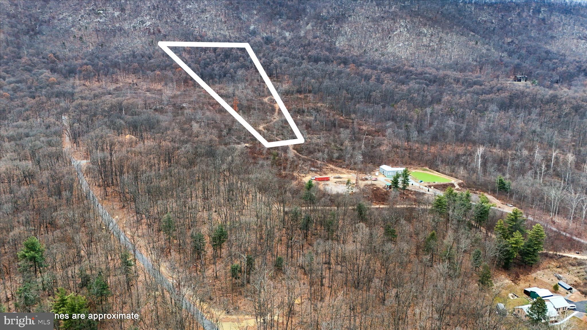 Welcome to Lot 4 on Bonaventure Way! This wooded lot backs directly to CACAPON STATE PARK,
 offering privacy, natural beauty, and a stream with potential for a pond. Winter months reveal views of the White Tail ski lift. The lot is residential only (no Airbnbs) and includes a $300 road maintenance fee. Conveniently located just minutes from Berkeley Springs, known for its historic mineral springs, charming downtown, local shops, and year-round recreation. A perfect setting to build your dream home in one of West Virginia’s most beloved small towns! Adjoining Lot 5 will be on the market soon.