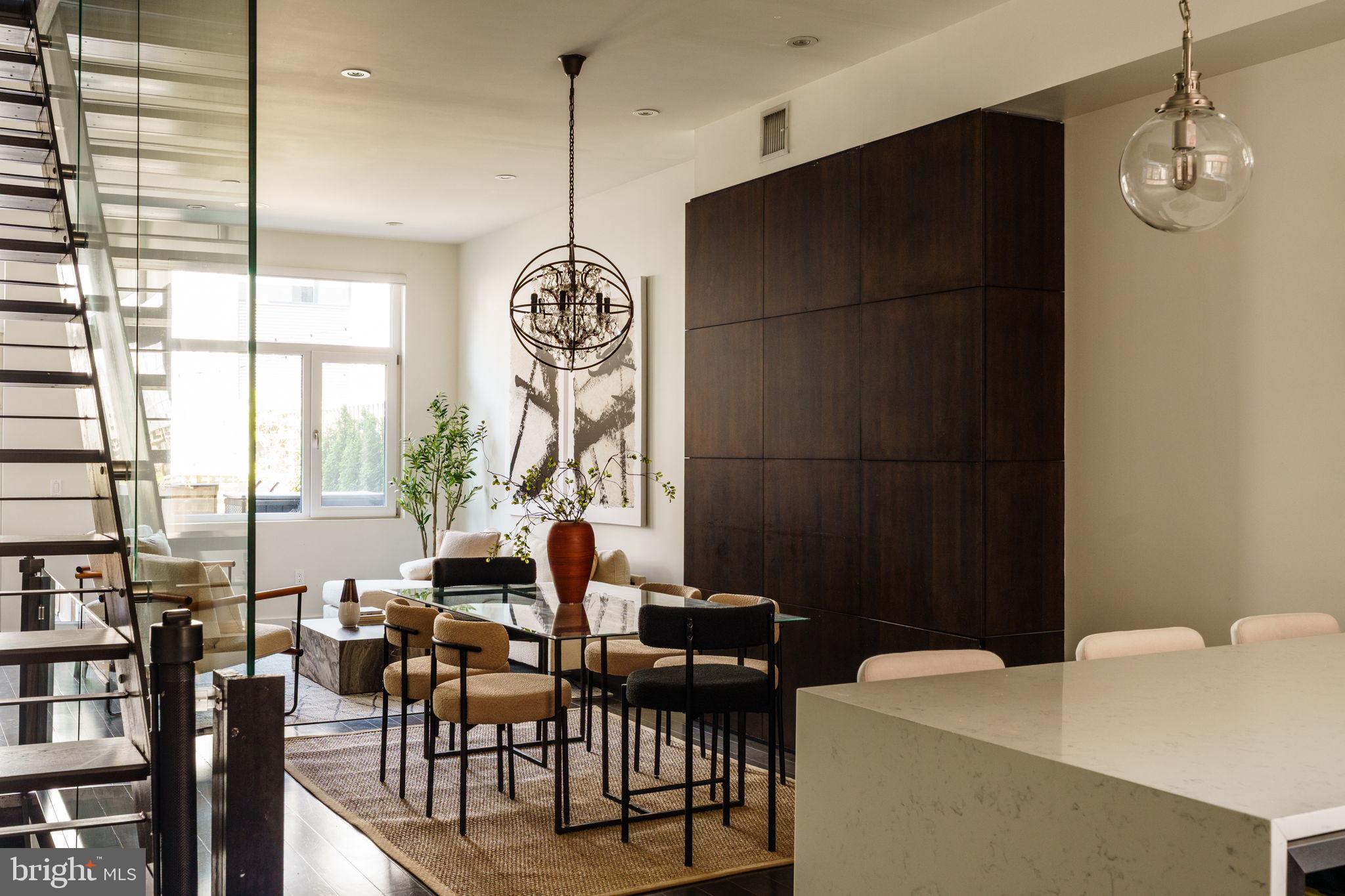 In a neighborhood defined by community, culture, and convenience, 227 W George Street offers a rare opportunity to enjoy the very best of Northern Liberties from one of its most desirable locations.

Built by one of the area's most respected builders, this thoughtfully designed residence spans approximately 3,300 square feet and pairs the scale and functionality of a single-family home with the walkability of city living. Complete with four bedrooms, three bathrooms, 2-car covered parking, a finished basement, and multiple outdoor spaces, the home offers a level of comfort and flexibility rarely found in the neighborhood.

Nearly every room has been enhanced with custom millwork, built-ins, tailored storage, high ceilings, natural light, high-end finishes, custom Hunter Douglas window treatments, and integrated Control4 entertainment with hardwired speakers inside and out. Built to passive house standards, the home also features energy-efficient windows and doors, enhanced insulation, 2-zone high-efficiency HVAC, and an HRV system.

One of the home's most compelling features is its unrestricted access to The Piazza's renowned amenity collection, including two resort-style pool decks and a state-of-the-art fitness facility, all within one block. Amenity rights are secured through 2031, offering a lifestyle that feels more akin to a private club than a city residence.

Just outside your door, enjoy easy access to some of Philadelphia's best restaurants, coffee shops, bars, fitness studios, shopping, parks, and dog parks. One block away is Liberty Lands Park, recently reimagined with expansive wooden play structures, open green space, and one of the most beloved community gathering places in the city.

At the heart of the home, an expansive chef's kitchen with a waterfall-edge quartz peninsula, stainless steel appliances, and custom locally crafted cabinetry opens seamlessly to a remarkable outdoor retreat. Surrounded by mature landscaping, the oversized deck creates a private oasis rarely found in the city, perfect for outdoor dining, entertaining, or unwinding under glowing string lights. Above it all, the roof deck captures sweeping views of the Philadelphia skyline and Ben Franklin Bridge.

With a quiet street setting, exceptional walkability, thoughtful customization, and rare access to resort-style amenities, 227 W George Street delivers an elevated urban lifestyle in the heart of Northern Liberties.