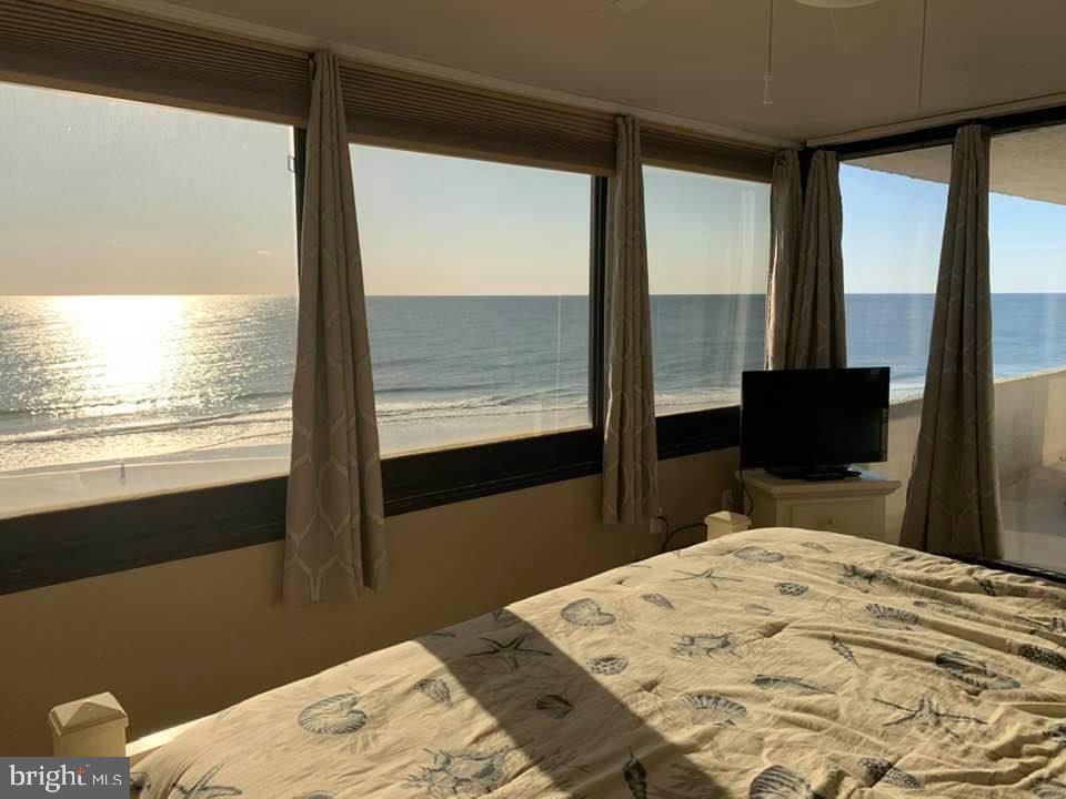 As the sun rises over the Atlantic Ocean, you awaken to the soothing sound of waves crashing against the shore. You open your eyes to the breathtaking view from your bedroom window, where the sky is painted in hues of pink and orange, signaling the start of a new day in your oceanfront condo.

You start your morning with a cup of coffee on the large oceanfront balcony, watching as the beach below comes to life with joggers, walkers, and groups of tourists and locals, alike, out for an early morning stroll. The salty sea breeze invigorates your senses as you take in the beauty of the ocean stretching out before you.

After breakfast, you head down to the beach for a day of sun and surf. With direct access from your building, you're just steps away from the sandy shore. You spend the morning soaking up the sun, swimming in the ocean, and building sandcastles with your family.

For lunch, you take a short walk to one of the nearby restaurants, where you indulge in fresh seafood and local specialties. After lunch, you explore the shops and boutiques, picking up souvenirs and gifts to remember your time in Ocean City.

In the afternoon, you return to your condo and relax by the heated pool, enjoying the warm sunshine and cool ocean breeze. You take a dip in the pool to cool off before heading back to your condo to prepare for the evening.

As the sun sets, you pour a glass of wine and settle in on the balcony to watch the sky turn vibrant shades of red and purple. The lights of the city begin to twinkle in the distance, creating a magical atmosphere.

For dinner, you cook a meal in your fully equipped kitchen, enjoying the convenience of having everything you need right at your fingertips. After dinner, you unwind in the comfortable living area, listening to the sound of the ocean and feeling grateful for the opportunity to call this place home, even if just for a little while.

As you retire to bed, you drift off to sleep to the sound of the waves, knowing that tomorrow brings another day of adventure and relaxation in your oceanfront paradise.