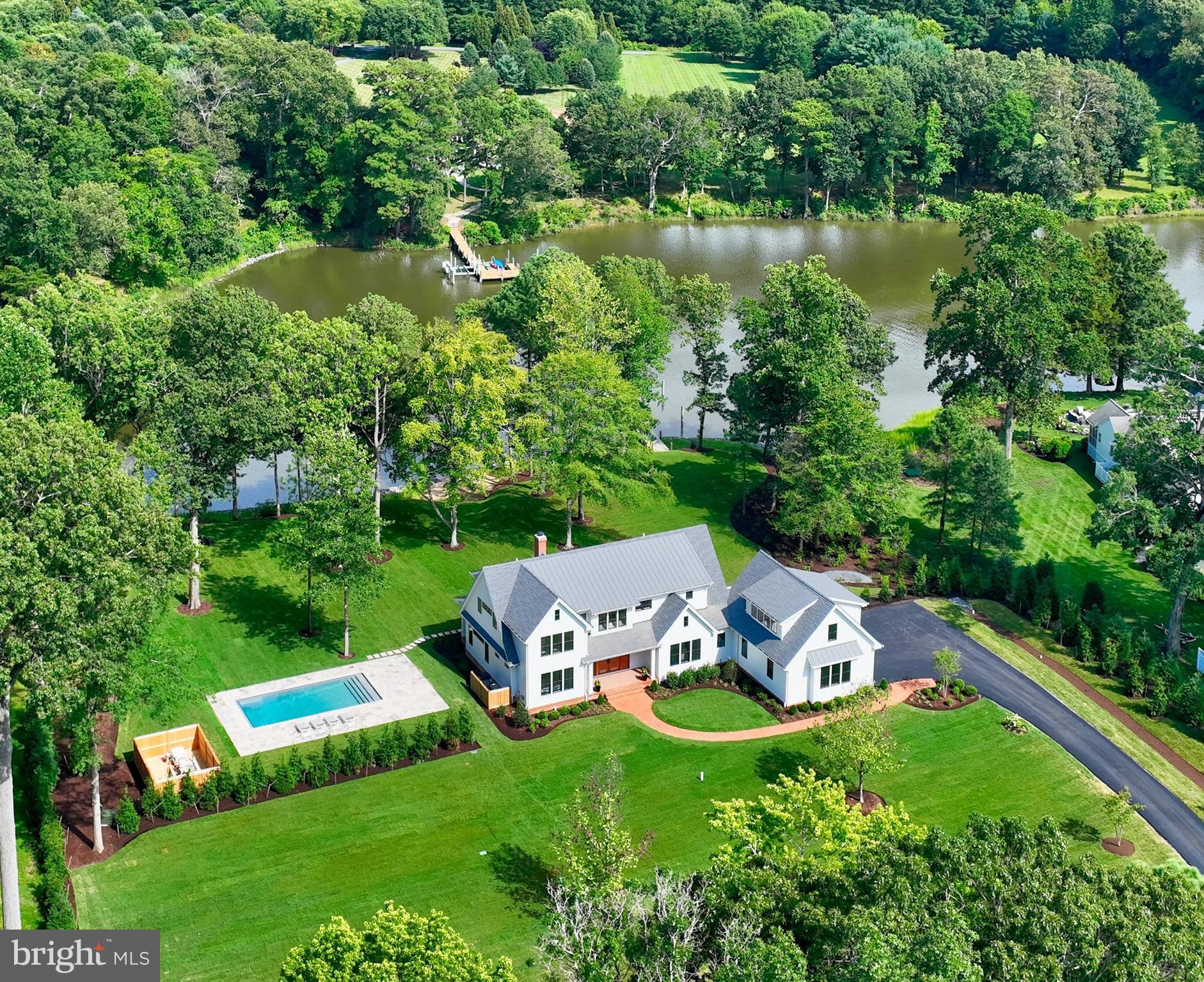 8051 Leehaven Road is the only property of its kind on the Eastern Shore right now — a custom-built waterfront estate that is fully furnished, move-in ready, and available today. This is not a project. It is not a renovation waiting to happen. It is +/-4,800 square feet of considered, uncompromising construction sitting on a private waterfront lot with direct access to the Chesapeake Bay, a Gunite saltwater pool with travertine surround, and a new pier fitted with water, electric, lighting, and three lifts — built to the same standard as the home itself. Focus Construction completed it in 2023, and the quality behind the walls matches what you see in front of them: sprayed insulation, a fully conditioned crawlspace, two tankless water heaters, full-house water filtration, and Hardie Plank exterior — every system selected for longevity, not appearance. Inside, the floor plan is generous without being excessive. Two primary suites — one on the main level — give the home the flexibility to accommodate full-time living, weekend retreats, and extended guests alike. The cook's kitchen is built to entertain. The bathrooms have heated floors, step-in showers, and a soaking tub. The living room and first-floor primary suite have motorized power shades. The fireplace anchors the main living space. The bonus room above the two-car garage has its own kitchenette — a private studio, a home office, or self-contained guest quarters, depending on what the next chapter of your life looks like. Every furnishing in the home is included. Every detail has been thought through and verified firsthand. You arrive, you put your bags down, and the Eastern Shore life that brought you here begins — not in six months, not after contractors and decisions and weekends lost to logistics, but the day you close. Easton and St. Michaels are minutes away. Annapolis is fifty minutes. Washington is ninety. There is nothing else like this available on the Eastern Shore at any price point right now. Offered at $5,245,000, completely turnkey, and ready for its next owner today. *By appointment only* *Do not enter the property without an appointment*