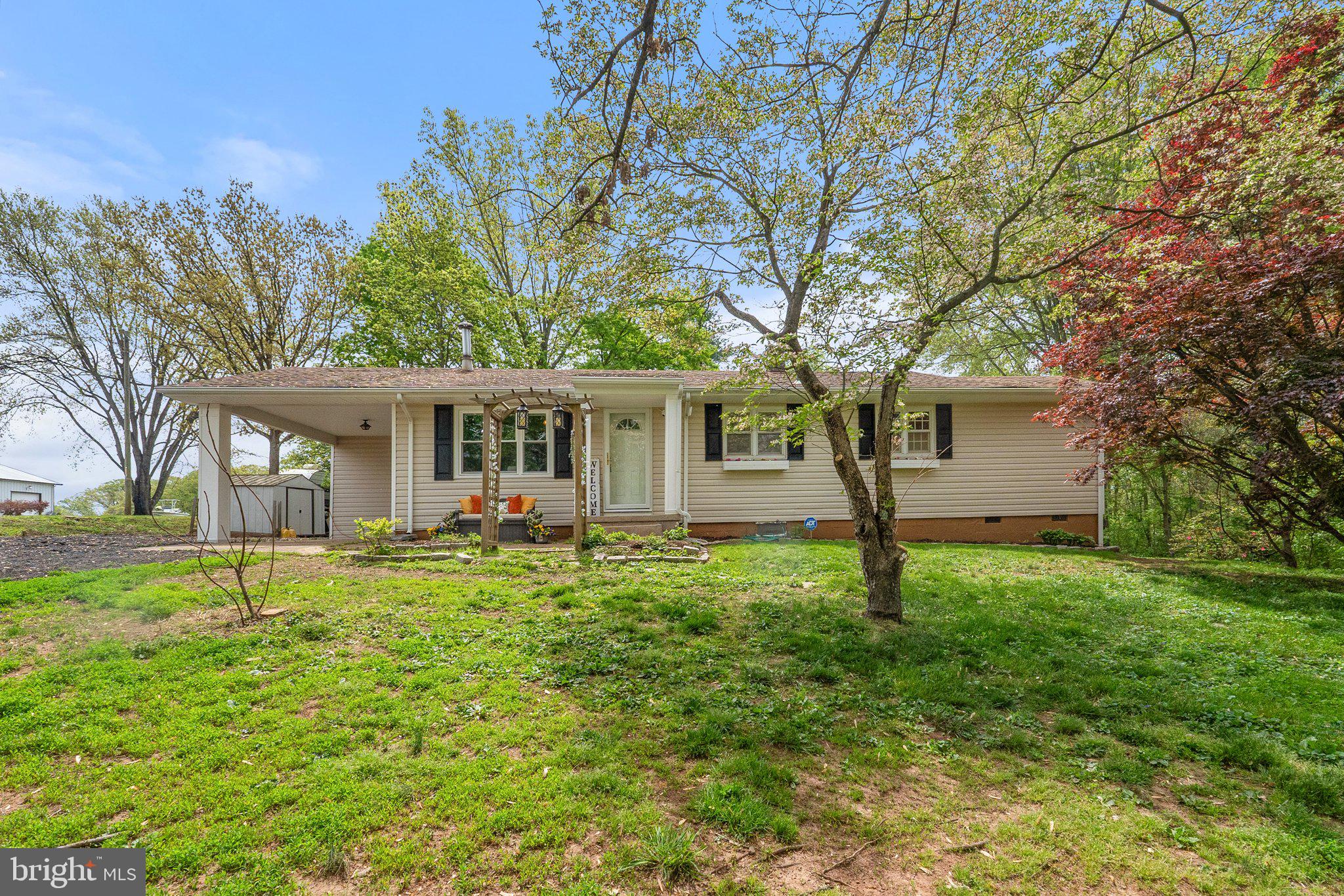 Located just off scenic Vint Hill Road, this little rambler gives you a lotta bang for your buck!  A single family home on just over an acre in Prince William County at a townhouse price? YES, it's true! The property adjoins the Prince William Golf Course and is close to the intersection of Rollins Ford Road, which transports you to Gainesville in a jiffy. And just 7 miles to the I66 Express Lanes is an added bonus!   This home offers a cozy living room w/wood burning stove, a separate dining room, a remodeled kitchen with custom, soft close cabinetry & granite counters, a true utility/laundry room, 3 bedrooms and 1.5 baths.  Refinished hardwood floors in the LR and bedrooms, ceramic tile in the kitchen and baths, and LVP in dining room and laundry room.  Brand  NEW Trane HVAC system and duct work, kitchen appliances all less than 5 years, water treatment system w/UV light, 3 years young, HWH 5 years so lots of peace of mind here. And septic you ask?  Alternative system installed approximately 13 years ago, maintained and inspected per county code.  The carport has a  storage room, and there is also a shed for lawn equipment. The driveway has been expanded and there is room for your camper! The backyard provides lots of trees, and a level yard for playing with the pups (invisible fence installed around entire yard) a fire pit area, and a raised concrete patio.  If you are ready to make a move to "close in country life" come see this ADORABLE  home today!