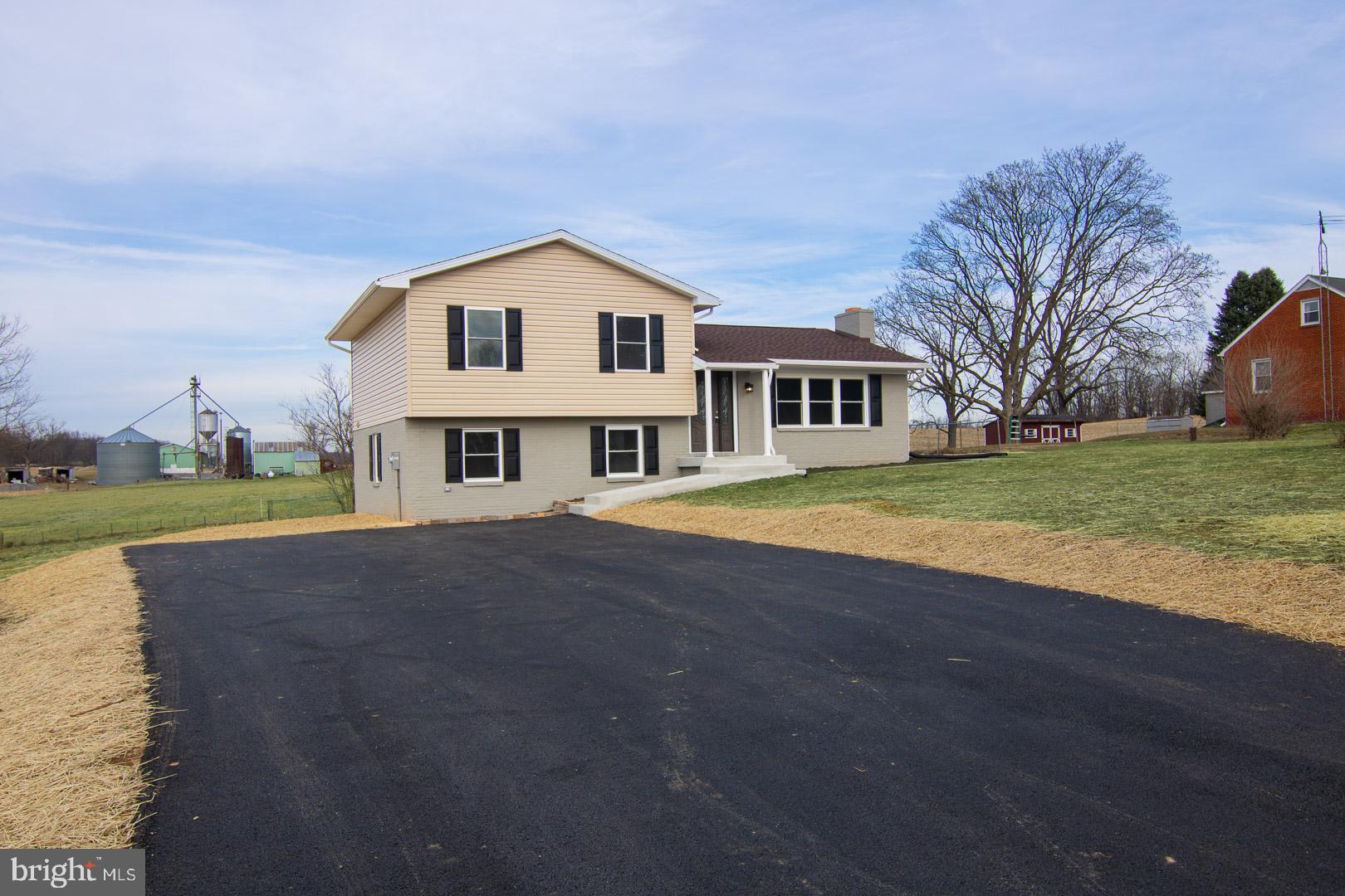 Welcome home! This beautiful split level is tucked in the picturesque Clear Spring countryside. This home has been NEWLY RENOVATED! Renovations include a new roof, windows, HVAC system, plumbing, and updated wiring and electrical service. Upon entry there is an open living area with a fireplace. The kitchen offers an adjacent dining area and brand-new stainless steel appliances. The large lower level is open and can become a second living area, rec room or oversized primary bedroom with an accompanying laundry room and half bath. The upper level offers two bedrooms, a stunning full bath, and primary suite with accompanying second full bath. There is gorgeous recessed lighting throughout with ceiling fans offered in many rooms. This home offers new carpeting and vinyl plank flooring throughout. Enjoy a relaxing evening with gorgeous mountain views on the brand-new back deck! Make this house your home today!