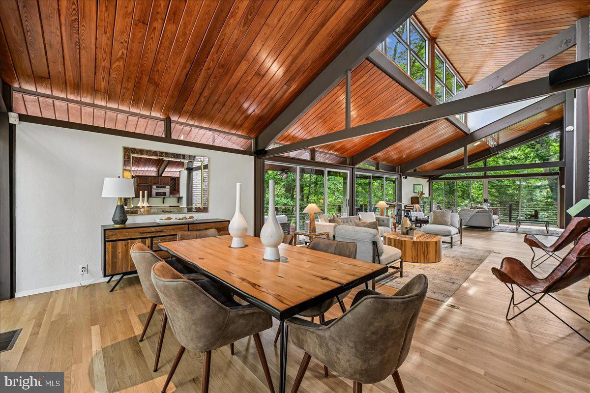 The Friedman House- 6620 Fernwood Court A truly exceptional architectural retreat, is set on a breathtaking 35,000+ square-foot wooded lot at the end of a cul-de-sac in the highly coveted Bradley Hills Grove neighborhood of Bethesda, Maryland. Surrounded by mature trees and tranquil natural vistas, this remarkable 4-bedroom, 3.5-bath custom built contemporary residence offers nearly 3,900 square feet of uniquely crafted living space. Its striking Mid-Century Modern design, refined comfort, and nature exist in perfect harmony. Delivering a rare sense of private woodland sanctuary within the Beltway, but just a few minutes from urban conveniences, this one-of-a-kind property embodies serenity, sophistication, and seamless connection to its extraordinary surroundings.

From the moment you enter, the dramatic sun-filled foyer establishes the architectural tone of the home. Vaulted tongue-and-groove cypress beam ceilings, expansive clerestory windows, and angular architectural glass create a light-filled atmosphere that shifts beautifully throughout the day. Newly refinished hardwood floors, exposed brick details, and soaring walls of glass infuse the interiors with warmth, character, and an unmistakable architecturally unique design for this coveted Bethesda neighborhood.

Designed for both everyday living and elegant entertaining, the kitchen features cherry cabinetry, granite countertops, a recently replaced five-burner cooktop, double convection ovens, a built-in microwave, dishwasher, separate ice maker, elevated breakfast bar, recessed lighting, and direct access to the outdoor living spaces. The adjacent living and dining areas are enhanced by a surround sound system and a wood-burning fireplace framed in exposed brick.

Multiple sliding glass doors extend the living experience outdoors, connecting the interior to a stunning wraparound Ipe hardwood deck with stainless steel horizontal ribbing, creating effortless indoor-outdoor flow beneath the canopy of mature trees.

The spacious primary suite serves as a private retreat, featuring an exposed brick accent wall, walls of windows and access to a flagstone patio and backyard, a walk-in closet with custom shelving, and a large ensuite bath with dual vanities, a glass-enclosed shower, and a separate soaking tub.

The secondary bedrooms are exceptionally spacious and thoughtfully designed, each featuring floor to ceiling windows or sliding glass doors that provide direct access to the backyard and surrounding grounds. One bedroom enjoys the privacy of an ensuite bath, while two additional bedrooms share a well-appointed hall bath with sink, offering both comfort and functionality for family and guests alike.

Additional highlights include a powder room on the main level, abundant storage space, a large linen closet, lower-level laundry and utility areas, a two-car garage with front door access, two-zone HVAC with advanced electronic air filtration, floodlighting around the home, a Generac generator and numerous recent updates.

Major improvements include a new roof (2020), new HVAC system (2022), new hot water heater (2022), upgraded drainage system, new water conditioner, air scrubber, generator, and professionally installed landscape lighting.

Offering a rare combination of unique architectural character and privacy in one of Bethesda's most desirable neighborhoods, this exceptional property presents a unique opportunity to enjoy tranquil living just minutes from downtown Bethesda, major commuter routes, shopping, dining, and top-rated public and private schools.