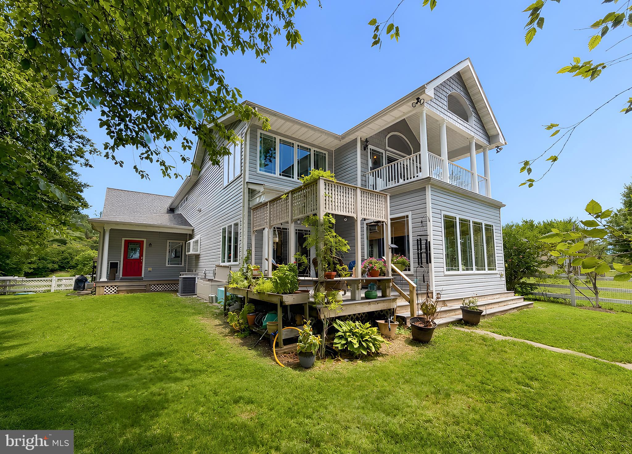 This exceptional custom home on a double waterfront lot offers nice privacy and premium boating access just minutes from the Patuxent River, Chesapeake Bay, and Solomons Island. The exterior features a 149-foot  pier with three  slips, a jet ski lift, and accommodation for a large sailboat(6-foot draft), alongside beautifully landscaped grounds, waterview porches and a plumbing-ready waterside shed.
An impressive 8-foot stained-glass front door opens to a dramatic two-story foyer and open floor plan featuring 10-foot ceilings and radiant-heated beautifully refinished oak floors. The gourmet kitchen boasts custom cabinetry, granite countertops, premium Wolf and Bosch appliances, new refrigerator, stylish backsplash and an expansive breakfast bar. It flows seamlessly into a dining room with loads of natural light and breathtaking water views . Also a cozy family room equipped with a gas fireplace and custom built-ins. A main-level guest bedroom, full bath, and mudroom complete the first floor.
Upstairs features luxury vinyl flooring throughout and an extra-large primary suite featuring cathedral ceilings with exposed barn beams, a gas fireplace, a large private waterfront balcony, and a spa-inspired bath complete with a unique heating stove, whirlpool tub, and custom walk-in shower. A second spacious bedroom and laundry room complete this level. A stunning spiral staircase leads to the unique tower solarium, offering panoramic creek views perfect for a meditation space or home office.
High-end mechanicals include an efficient Buderus furnace (powering domestic hot water and the radiant floors across the main level and the oversized, heated 2-car garage/workshop), a 13kW Generac whole-house generator and central vacuum!