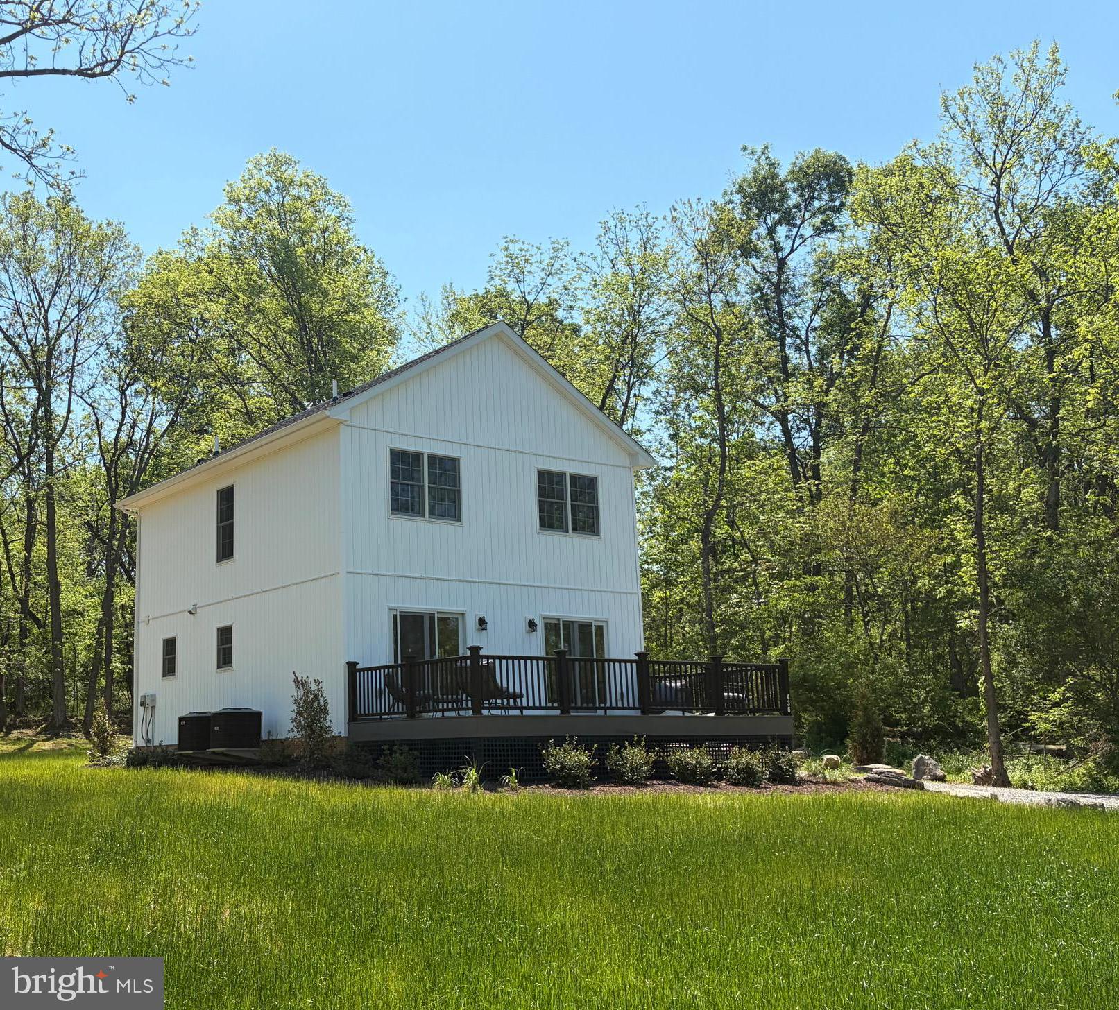 Are you searching for a serene place to call home?  Welcome to this brand new charming two-story, 3 bedrooms, 2.5 bathroom,  Craftsman style home set on a picturesque half acre lot, surrounded by scenic horse farms that will never be subdivided. This property offers both privacy and timeless rural & rustic beauty. Inside, you’ll find a thoughtfully designed layout with comfort and style in mind. Luxury vinyl plank flooring runs throughout the home, creating a warm and cohesive feel.  On the main level, you'll find the convenient half bath with laundry, separate dining area that flows into the inviting great room that serves as the heart of the home, highlighted by a contemporary wall-mounted fireplace that adds a modern touch. Step outside onto the large Trex deck with sylish black iron railings  just off the great room—an ideal space for relaxing, hosting gatherings, or simply enjoying the peaceful countryside views. The kitchen features elegant quartz countertops and stainless steel appliances, perfect for both everyday living and entertaining. Upstairs are the three bedrooms including the spacious primary bedroom with the nicely appointed primary bathroom. Among the upper level is also the other full bathroom. Rare opportunity to own a cottage set amongst fine farms in horse country. Be the first to enjoy this new home!