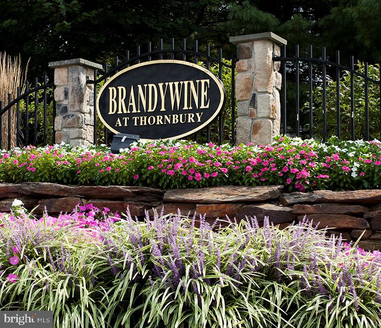This beautifully maintained 3‑bedroom, 2.5‑bath townhome in the sought‑after Brandywine @ Thornbury community offers a sophisticated blend of high‑end detail and everyday comfort. Located on a quiet cul‑de‑sac, the home immediately impresses with wide‑plank hardwood floors and classic touches like wainscoting and crown molding that carry through the open living and formal dining areas. The heart of the home is the stunning family room, where vaulted ceilings and floor‑to‑ceiling windows frame a gas fireplace and flood the space with natural light. It flows seamlessly into the updated kitchen, featuring a new center island, granite countertops, and stainless steel appliances. Whether you’re prepping a weeknight meal or hosting friends, the layout works beautifully, especially with sliding glass doors leading to a private deck overlooking a wooded backdrop.
Upstairs, the primary suite serves as a true retreat with dual walk‑in closets and an ensuite bath offering a double vanity and oversized shower. Two additional bedrooms, a full hallway bath, and a dedicated laundry room complete this level.
The living space continues in the expansive finished basement, an ideal hangout area with a built‑in bar and plenty of room for a kids’ playroom, home gym, or theater setup. A large, versatile separate room provides the perfect spot for a quiet home office or even a potential fourth bedroom.
Located in the award‑winning West Chester Area School District, feeding into Bayard Rustin High School. The reasonable HOA fee includes access to a community pool, tennis courts, basketball court, tot lot, and clubhouse. All just minutes from major highways, parks, schools, and shopping. Make this your new home today!