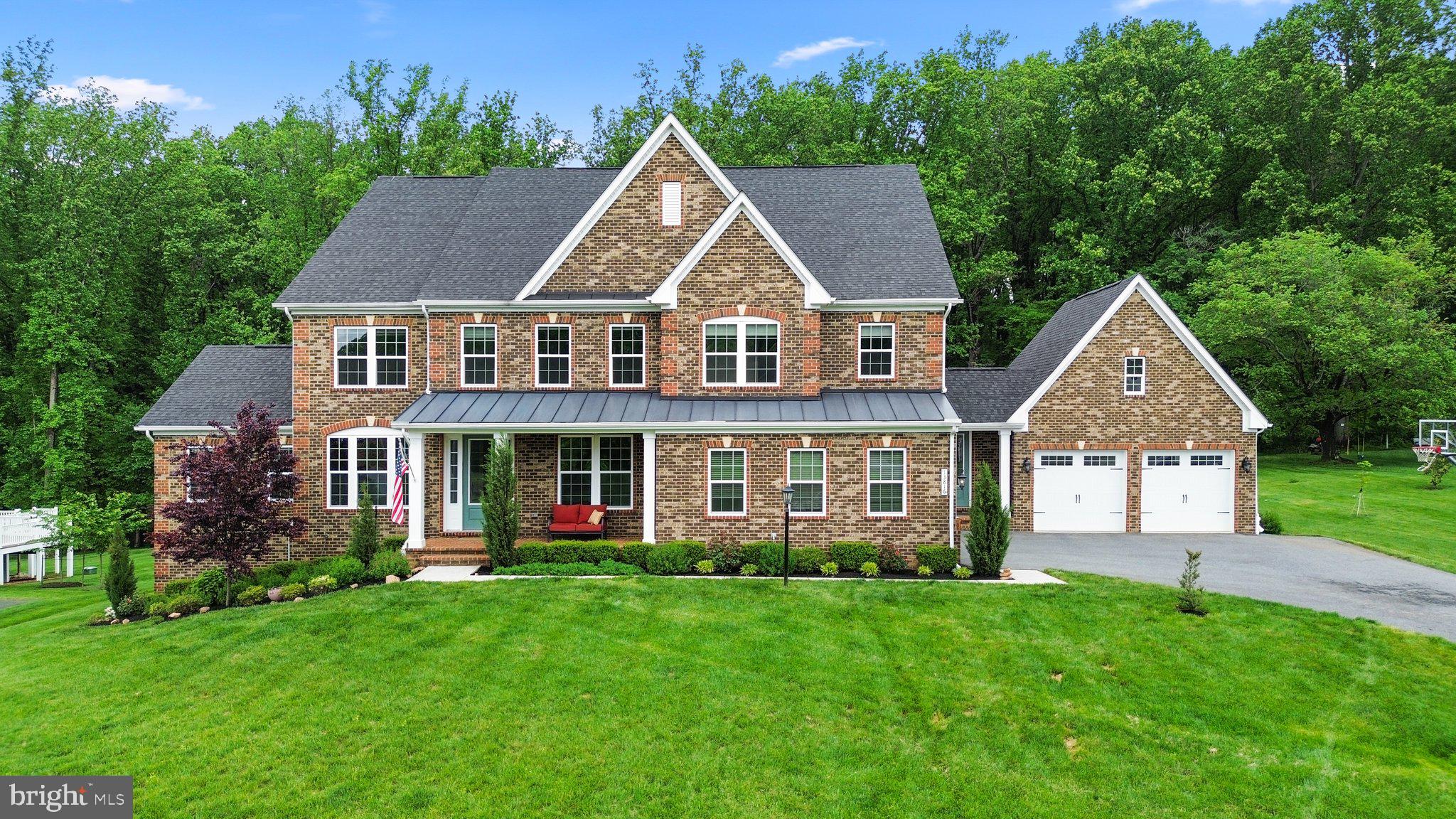 Impeccable estate-style residence with over 7,400 sqft of living space.
Serene setting with beautiful views in The Estates at Mill Creek meticulously maintained by the original owner. Professionally landscaped homesite with lush greenery with a large covered deck overlooking backyard and mature trees. This handsome home is sure to impress - with a stately elevation, welcoming front porch, covered back porch, manicured landscaping, elegant interiors drenched in natural light, and fine finishes throughout. A stunning foyer entry with gleaming hardwoods leads to the flowing floorplan featuring a formal living room, formal dining room, two-story family room with gas fireplace, study or office, laundry room, mudroom with built-ins, butler pantry, powder room, and guest suite with full bath. A chef's delight, the signature kitchen is equipped with quartz counters, high-end appliances including a 5-burner gas cooktop, decorative pendant lighting, tile backsplash, a huge island with breakfast bar, and a bright breakfast room accessing the covered deck. Retreat to the hotel-like owner’s suite with a walk-in closet and a spa-like bath featuring raised-height dual vanities with granite countertops, a gleaming walk-in shower featuring frameless glass, and a soothing platform soaking tub. All additional bedrooms include an attached full bath and a walk-in closet. One of these bedrooms is the main level suite, ideal for an in-law suite or a guest suite for visitors. The finished lower level hosts a rec room with a walkout to the spacious yard, a bonus room, a full bath, and an unfinished room for storage. Enjoy plenty of space for vehicles, tools, and equipment in the two impressive 2-car garages – one front-entry and the other side-entry. Embrace the spirit of relaxation and entertaining on the expanded covered deck with skylights overlooking a tree-lined manicured backyard. The property boasts an array of elements that conserve energy and water, dual zone HVAC, energy efficient windows, a Smart Thermostat, and Wi-Fi enabled garage door openers that you can control from your smart device. This sought-after community boasts scenic tree preserves with unmatched access to the everyday amenities of River Hill Village Center, Maple Lawn, and Olney. Enjoy high-end shopping at nearby Columbia Town Center, or take the short half-hour drive to BWI Airport for an easy weekend getaway. Clarksville offers ideal access for both DC and Baltimore
commuters.

Minutes away from dining, shopping, parks, commuter routes, and more