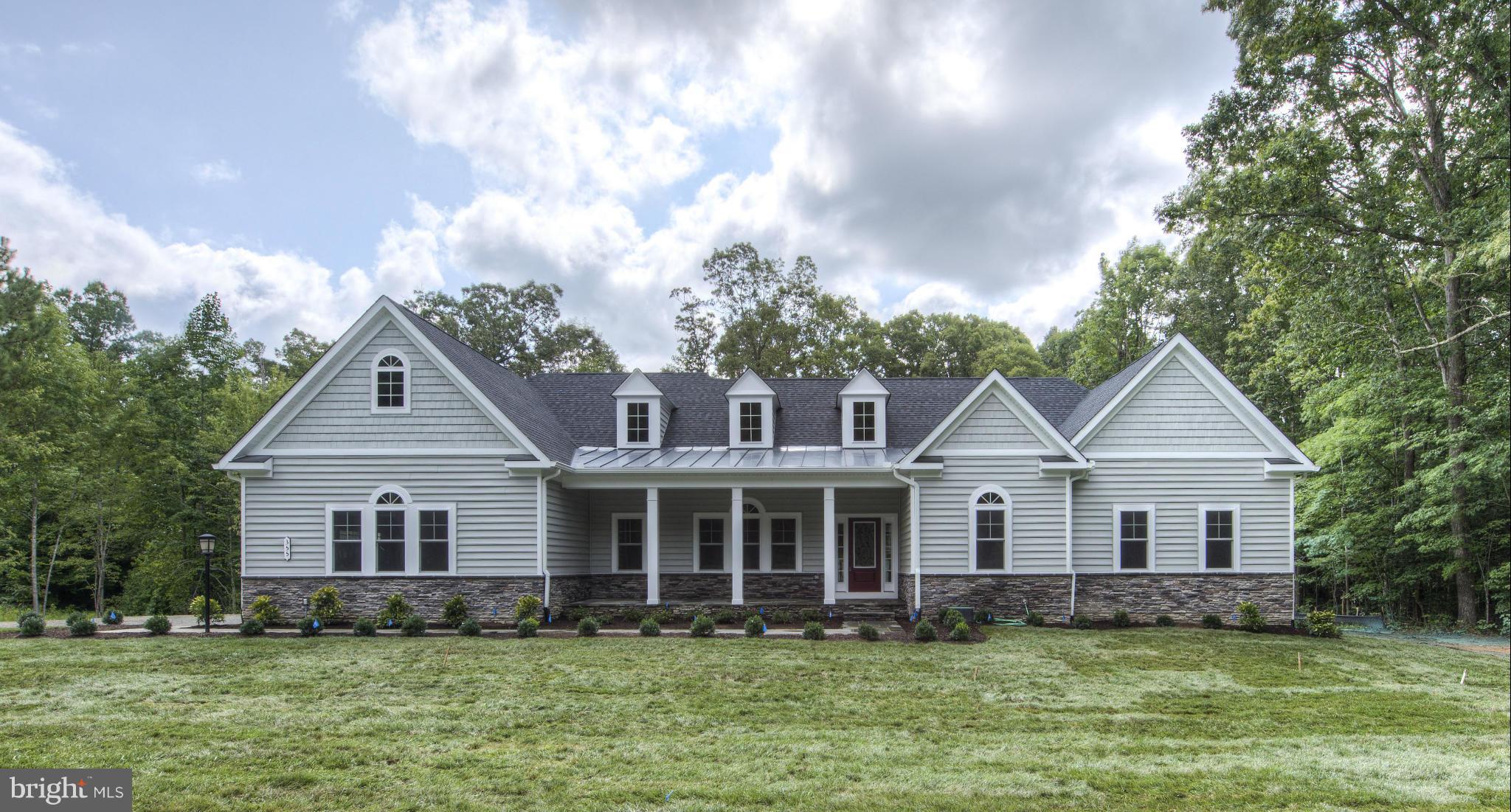 Custom home on 3 acres of wooded land .Open Floor plan w/ 3000 sq. ft on one level w/ wood floors,gourmet kitchen w/ maple cabinets, tile backsplash & granite,large pantry,breakfast room, separate formal dining room, large family room w/ gas fireplace w/  custom mantle, high ceilings, wood floors, walk in closets, ceiling speakers in master and family room. Safe room in basement.