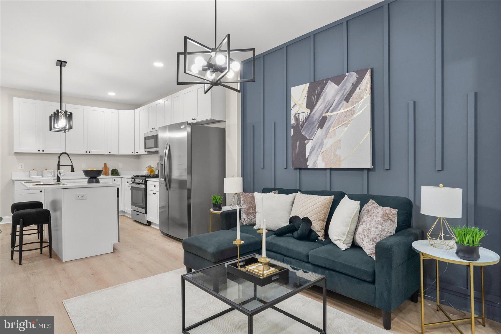 Beautifully renovated, classic Baltimore townhome that perfectly blends timeless character with modern style. From the moment you step inside, you'll appreciate the thoughtful updates, contemporary finishes, and inviting open layout designed for today's lifestyle.

The sun-filled main level showcases elegant tray ceilings, recessed lighting, modern fixtures, and a striking accent wall that creates a stylish focal point in the living room. The beautifully designed kitchen is a standout, featuring stainless steel appliances, abundant cabinetry, a spacious center island, and contemporary pendant lighting—perfect for cooking, entertaining, or casual dining. The available front room provides flexibility for either an additional bedroom, or at-home office.

The lower level offers even more comfortable living space along with a convenient half bathroom, and an extra bedroom.

Upstairs, you'll find two bright and spacious bedrooms filled with natural light, along with two beautifully updated full bathrooms featuring sleek, modern finishes.

With its seamless blend of classic Baltimore charm and today's most desirable updates, this move-in-ready home is the perfect place to call your own!

***Located within close proximity to Johns Hopkins University and Johns Hopkins medical campuses, Charles Village and Hampden, the Waverly Farmers Market and local YMCA, commuter routes and Penn Station, local convenient stores, and the neighborhood garden, you won't struggle to both find things to do and easy drives (or walks) to get to them.