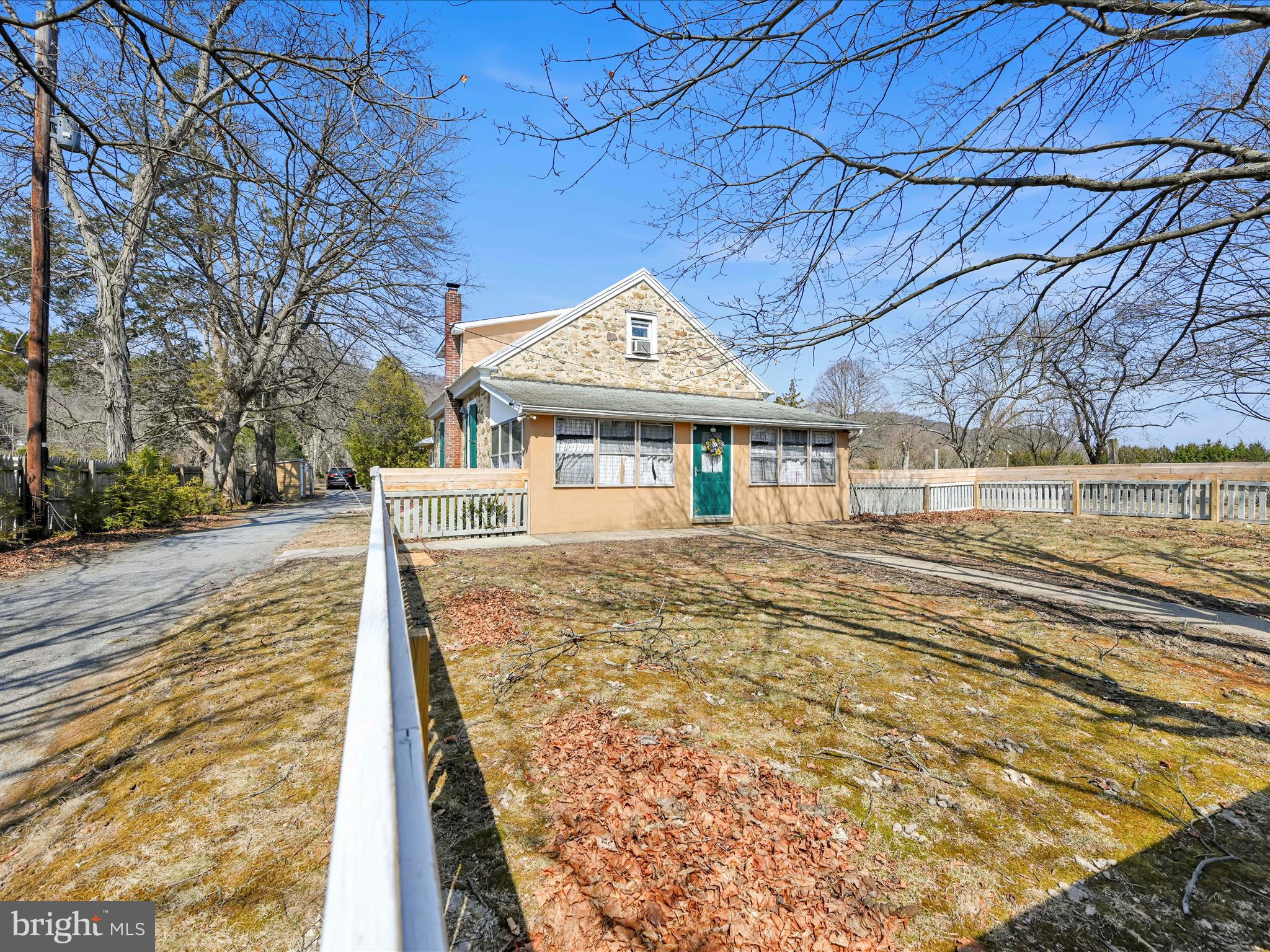 Step into history with this one-of-a-kind home in Auburn, originally built in 1878 as a one-room schoolhouse. The Mengel School House was decommissioned in 1943 and converted into a residence in 1947, this cherished property has been in the same family for 78 years. This solid home has 30-inch stone walls and beautiful original windows on the lower level, offering a glimpse into its storied past. The second floor was later added and just recently finished into living space. The layout includes three upstairs bedrooms, two full baths (one on each floor), and a spacious laundry/mudroom at the rear of the home. New furnace installed in October. Enjoy relaxing on the enclosed front porch, perfect for unwinding after a long day with a fenced in front yard perfect for the kids or pets. Outside, the property offers plenty of space and functionality, featuring a large shed with a wooden deck, a dog kennel with an additional shed, and a two-story workshop with two-bay garage providing ample storage and workspace . The through-driveway offers access from both Route 895 and Fort Lebanon Road which is very convenient. Additionally, this property also includes the parcel across the street which makes the total acreage 3. 4 acres. Mature beautiful landscaping will amaze in the Spring along the driveway and all over the property. While the home could use some repairs and updates, it presents endless potential for those looking to restore and personalize a piece of local history. Don’t miss this rare opportunity to own a unique, character-filled home! Schedule your private showing today!