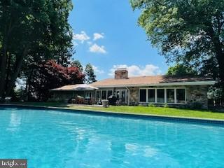 Private 1-Acre Lot in Desirable West Chester Boro – Walk to Restaurants & Shops
This newly renovated ranch-style home offers the perfect blend of luxury and comfort with 3,236 sq. ft. of thoughtfully designed living space. Set on a private 1-acre lot with an in-ground pool, expansive patio, an elevator to the lower level and a 3-car garage, the property provides a rare combination of privacy and convenience within walking distance to the heart of West Chester.
Inside, the home features hard wood flooring, two fireplaces, and abundant natural light. The gourmet kitchen is equipped with high-end Thermador appliances, marble and soap stone countertops and custom cabinetry—ideal for entertaining.
The home includes 4 bedrooms and 5.5 bathrooms (1 full bath in pool house).  Additional highlights include a main floor laundry and an expansive finished basement.