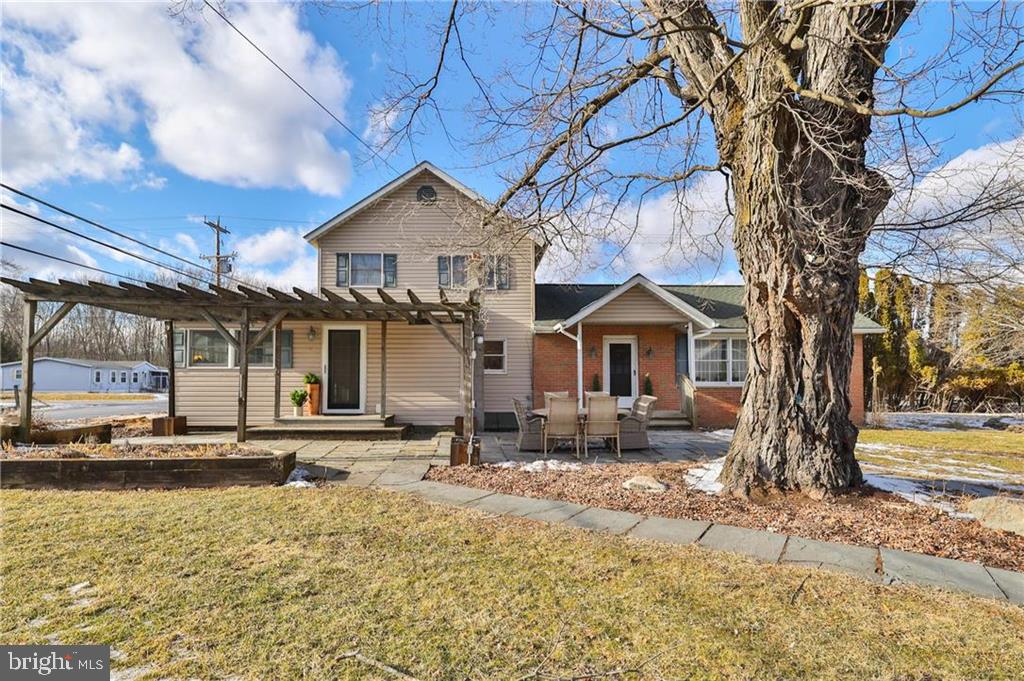 Discover the perfect blend of historic charm and modern convenience in this enchanting 5-acre farmette, less than 40 minutes from Bethlehem. This 1902 farmhouse exudes warmth, featuring two inviting bedrooms and two full bathrooms. The main level offers a spacious living room, a cozy dining room with wood built-ins, and a charming staircase that enhances its timeless appeal. The generous eat-in kitchen is complemented by a scullery—ideal for prep work, entertaining, and pantry storage. A first-floor laundry/utility room adds convenience, while a bright front sunroom provides a peaceful retreat. The large attic offers exciting expansion potential. Thoughtful updates, including modernized systems, a new septic, and updated heating, ensure a move-in-ready experience. Outside, enjoy a large in-ground pool with a new pump and filter, fresh landscaping, a rock garden, and fragrant lavender plantings. The property features an oversized two-car garage & covered patio, plus one-car garage, and a spacious one-story barn—ideal for livestock, storage, or a creative workspace. A predator-proof chicken coop, garden beds, and a newly planted orchard w/ 15+ heirloom fruit varieties, enclosed by a 6-ft deer fence, make this a gardener’s dream. A slate patio and perennial herb garden complete the outdoor retreat. With land spanning both sides of a quiet country road, privacy abounds. Due to relocation, this rare opportunity is now available! This property is NOT in a flood zone.