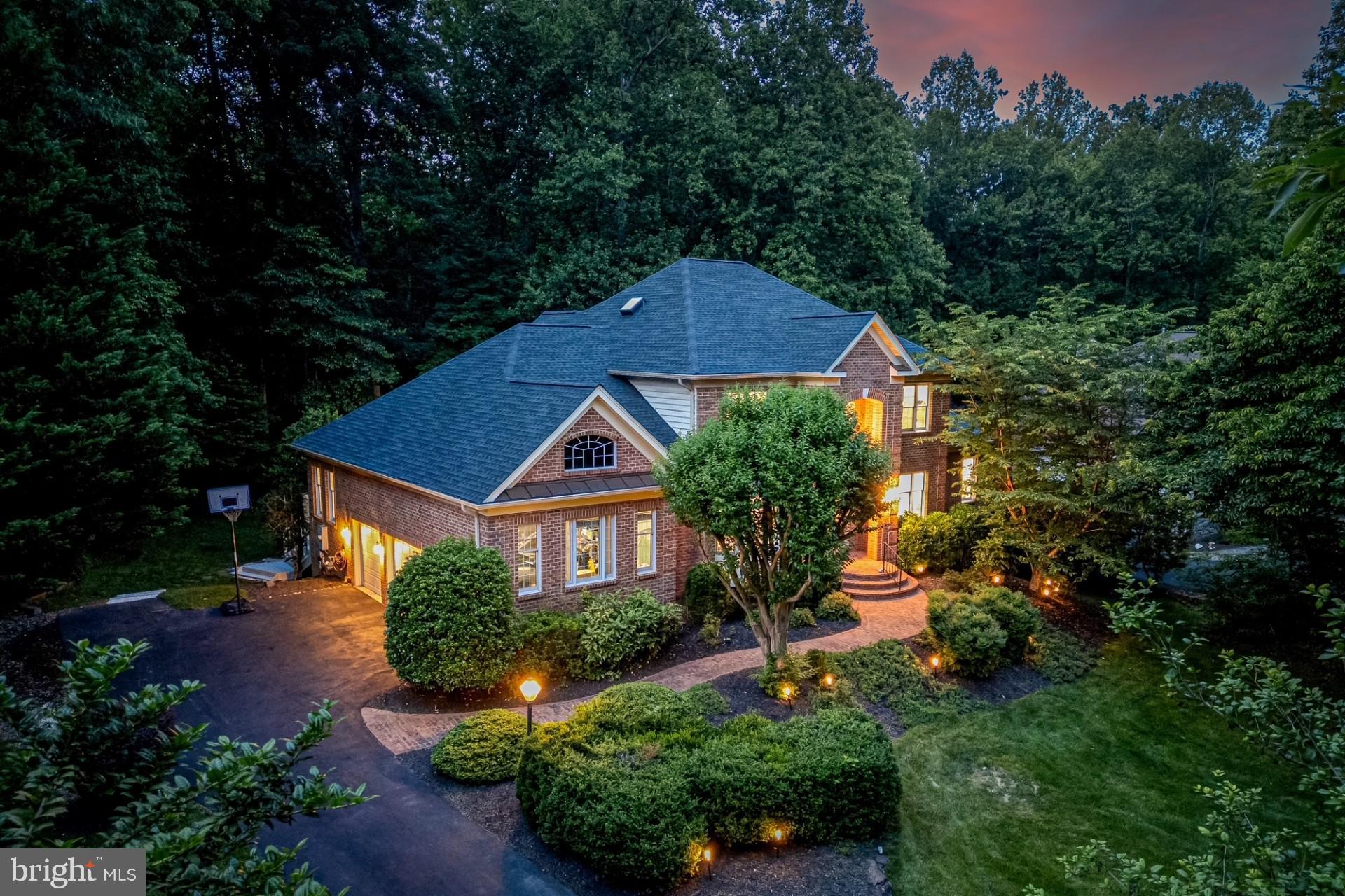 Open House12pm - 4pm on 3/7/26(SAT), 1pm - 4pm on 3/8/26(SUN)
This 6,000-square-foot colonial home backs to quiet wooded parkland. The property is exceptionally well-maintained and features a layout designed for versatile, multi-generational living.

Main-Level Primary Suite: A key feature is the first-floor master bedroom. This layout provides easy accessibility and the convenience of having all essential living spaces on the main floor.

Multi-Generational Potential: The fully finished walk-out basement provides a complete secondary living area. This independent space makes the home ideal for three-generation living, offering privacy for extended family.

Privacy and Quality: The home backs to protected greenery, providing a natural retreat. Throughout all three levels, the property shows true pride of ownership and meticulous care.

Inside, you'll find five generous bedrooms, all with hardwood floors, and five marble-appointed bathrooms. The large, sun-filled rooms are enhanced by gracious moldings, while the gourmet kitchen is a showstopper with granite countertops, stainless steel appliances, and a new quartz island (2024).

Outdoor living is a joy with an oversized Trex deck overlooking the woods and a beautifully maintained backyard with mature trees. The property also boasts direct access to a private, circular trail, a cherished amenity for local residents. Additional features include a 3-car side-load garage, Bose sound system, whole house vacuum, and Vector security system. Recent updates include a new roof (2023), kitchen quartz island(2025),  master bathroom quartz vanity top(2025), deck sealing(2025) and driveway sealing (2025).

A major highlight is the convenient main-level primary bedroom, providing easy access and a private oasis. This spacious suite leads directly to a luxurious, marble-covered spa-like bathroom, making everyday living feel like a retreat.

Inside, you'll find five generous bedrooms, all with hardwood floors, and five marble-appointed bathrooms. The large, sun-filled rooms are enhanced by gracious moldings, while the gourmet kitchen is a showstopper with granite countertops, stainless steel appliances, and a new quartz island (2024).

Outdoor living is a joy with an oversized Trex deck overlooking the woods and a beautifully maintained backyard with mature trees. The property also boasts direct access to a private, circular trail, a cherished amenity for local residents. Additional features include a 3-car side-load garage, Bose sound system, whole house vacuum, and Vector security system. Recent updates include a new roof (2023), kitchen quartz island(2025),  master bathroom quartz vanity top(2025), deck sealing(2025) and driveway sealing (2025).