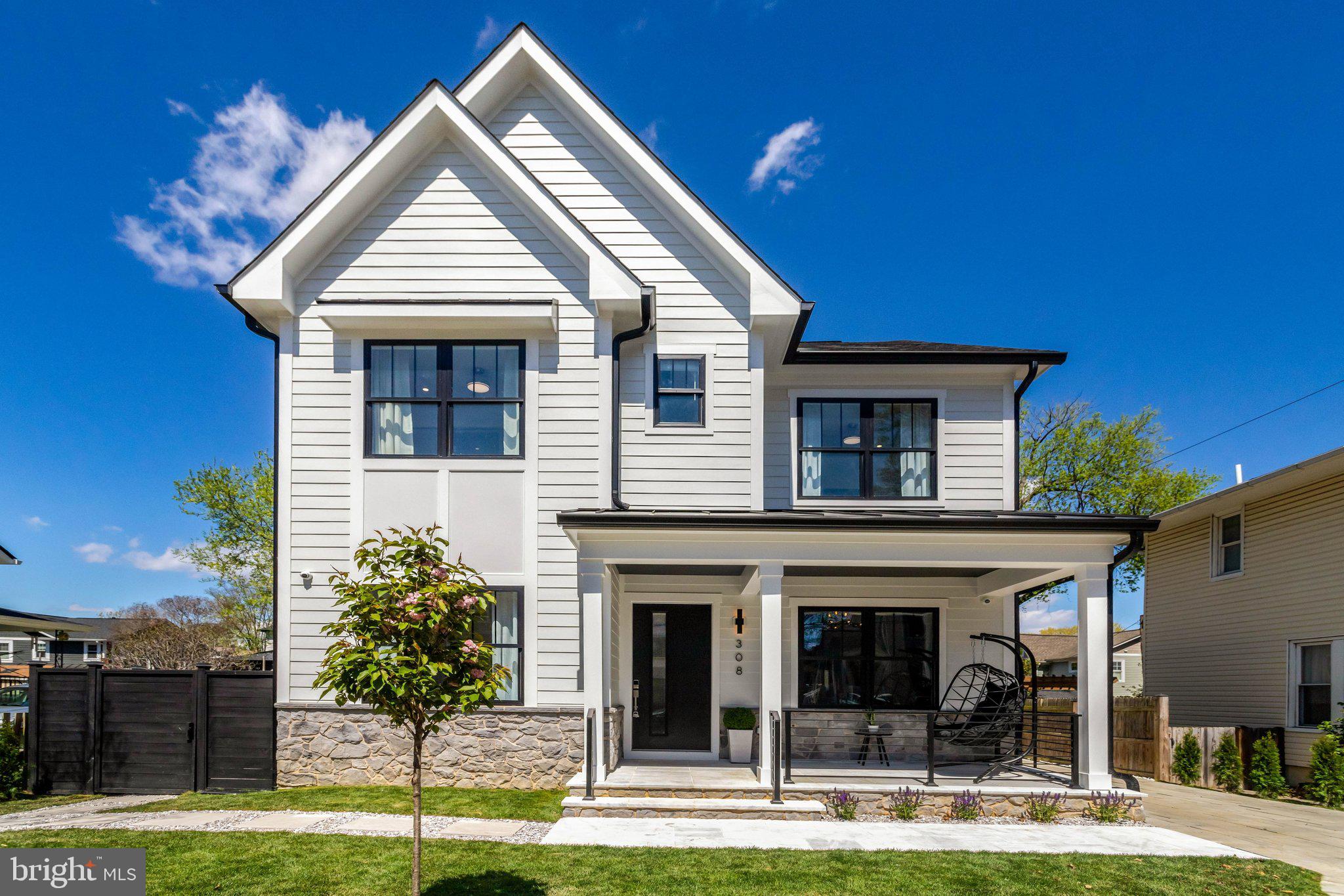 Seven minutes to Reagan National. Walking distance to two Metro stations. New construction with a Wolf/Sub-Zero kitchen, retractable glass walls to a covered outdoor porch with  fireplace, oversized garage, and a primary suite with a private balcony — delivered in 2026 with a builder warranty.

This is the only new-construction home of this caliber available in Del Ray, Alexandria's most sought-after neighborhood — and the location alone makes it exceptional. Reagan National Airport is 7 minutes away. The Pentagon, National Landing/Amazon HQ2, and Old Town Alexandria are under 15 minutes. Two Metro stations are within walking distance, and the neighborhood's signature "The Avenue" — boutique restaurants, shops, and weekend farmers market — is steps from your door.

The luxurious home was designed for executives who entertain and live well. The chef's kitchen is anchored by a 48-inch, 6-burner Wolf range with infrared griddle, a paneled Sub-Zero refrigerator, a Wolf drawer microwave, and a paneled Bosch dishwasher — all framed by a dramatic Calacatta Safyra waterfall island and backsplash with dual-tone soft-close cabinetry. A butler's pantry and an extraordinary custom walk-in pantry with floor-to-ceiling cabinetry and built-in pull-outs keep the kitchen working as well as it looks.

The family room opens through fully retractable glass doors to a covered rear porch with a wood-burning fireplace — a seamless indoor-outdoor connection that extends your living space in every season. Rich white oak hardwood floors run throughout the main level, which also includes a formal dining room with tray ceiling, a main-level study or optional sixth bedroom with full bath, a mudroom, and an additional full bath.

Upstairs, the primary suite is a genuine retreat: private balcony, dual custom walk-in closets, and a spa bath with a custom double marble vanity, soaking tub, dual shower heads, and body sprays. Three additional bedrooms offer en-suite and buddy bath arrangements; upper-level laundry adds everyday convenience.

The fully finished walk-up lower level is built for maximum flexibility — a stylish wet bar with a paneled Fisher & Paykel refrigerator and Bertazzoni dishwasher, a dedicated yoga and fitness studio, a private bedroom suite with full bath, and a walk-out entrance. Ideal for guests, an au pair, or multigenerational living.

Technology and systems match the finishes: dual-zone Carrier HVAC with Nest thermostats, a Juke integrated audio system with interior and exterior Bose speakers, a Dahua 6-camera security system, a Tesla EV charger in the oversized detached garage, and ENERGY STAR-certified appliances and windows throughout. A fully fenced backyard and 3D virtual tour are available online.

 No HOA. Builder warranty included.