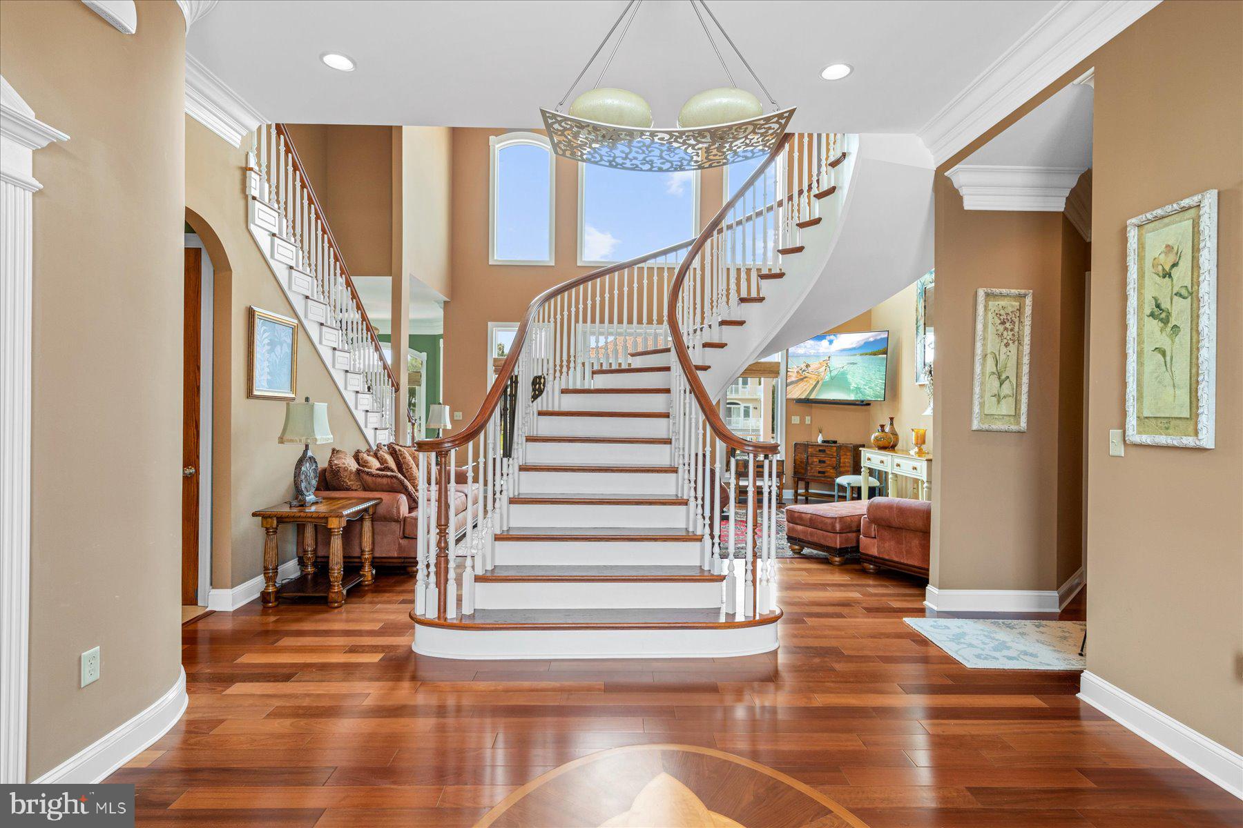 This exquisitely designed home is the total expression of resort style living. It is positioned flawlessly on a 90' coastal lot. The showplace professional open kitchen is the center of this home with multiple entertaining spaces. Distinguished design choices and attention to details are prevalent throughout. Sundrenched decks add to the appeal of this home. Special features include a fully equipped dock with a Golden top mounted 16,000lb boat lift and two swivel PWC lifts complete the ultimate outdoor pleasure. Lasting memories will undeniably be created enjoying this tranquil oasis.