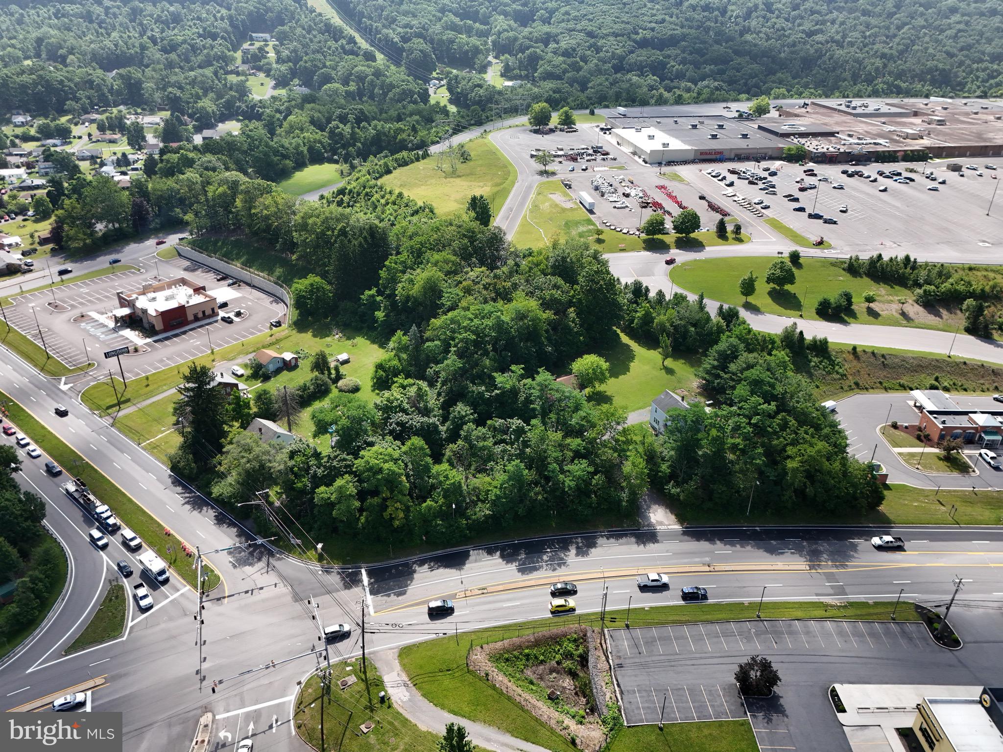 Position your business for success with this exceptional 1.66-acre commercial property located at one of the busiest intersections in Allegany County. Situated on a corner lot with outstanding visibility and exposure, the property sees over 12,000 motor vehicles per day and is conveniently located adjacent to Interstate 68 Exits 39 and 40.
This prime development site abuts the Country Club Mall and is surrounded by established national and local retailers, restaurants, hotels, and other commercial businesses, placing your future development at the center of one of the region’s premier retail corridors.
Zoned commercial and comprised of four parcels, the property offers all public utilities on site and includes two existing single-family homes, providing flexibility for future redevelopment.
Whether you’re planning retail, restaurant, hospitality, office, medical, or another commercial venture, this rare offering combines exceptional visibility, accessibility, and location to create an outstanding investment and development opportunity.