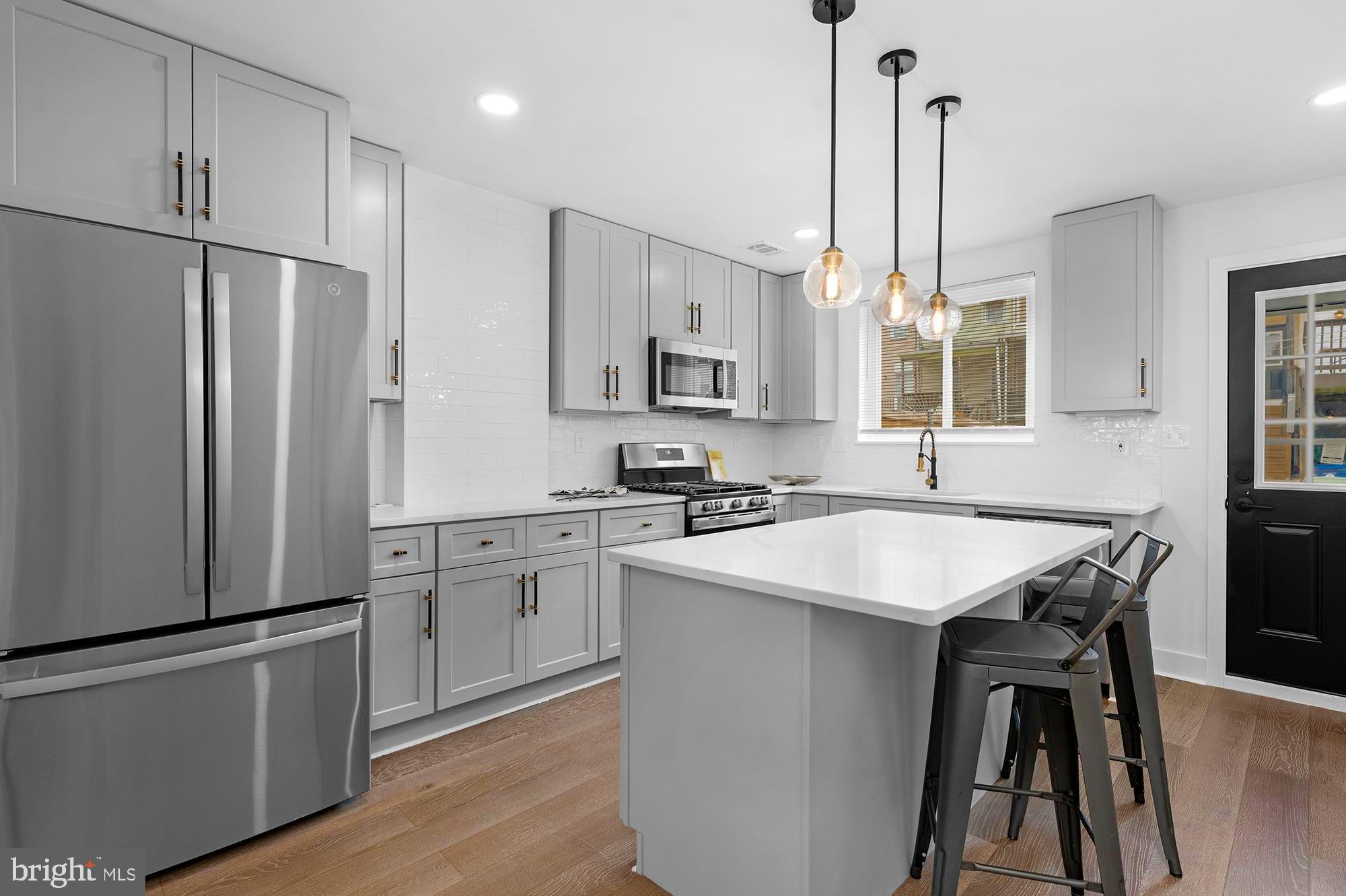 Welcome to 231 S Bouldin Street, a stunning modern renovation with custom touches throughout. Step inside and be captivated by the open floor plan, where contemporary design meets timeless elegance. The main floor impresses with high-end, West Coast-inspired wide plank floors, a decorative fireplace adorned with full-format tile, a cozy electric fireplace, and stylish accent lighting. 

Flowing seamlessly into the dining area and kitchen, this space is perfect for entertaining. Designer light fixtures add a sophisticated touch, enhancing the warm and inviting ambiance.

The beautifully designed eat-in kitchen features a spacious island, sleek gray shaker cabinets, a stylish subway tile backsplash, and plenty of storage. Stainless steel appliances complete the modern aesthetic, making this kitchen as functional as it is visually striking.

The second floor boasts a luxurious primary suite with a spa-like bathroom featuring a walk-in shower with elegant Italian tile, a custom herringbone design, built-in niches, a modern vanity, modern lighting, and brushed gold fixtures. The spacious second bedroom is accompanied by a beautifully appointed hallway bath, complete with a soaking tub, a large vanity, and more exquisite timelessly designed tile.

The finished lower level offers a versatile flex space that can easily serve as an additional guest suite with its own private bathroom. Whether used as a family room, home office, or extra bedroom, this space provides endless possibilities to suit your lifestyle.

Enjoy the convenience of a private parking pad, making city living effortless. Located within walking distance to Patterson Park and offering easy access to Canton, Fells Point, Johns Hopkins hospitals, and major highways, this home perfectly blends modern luxury with unbeatable convenience.

Come, see, and move right in!