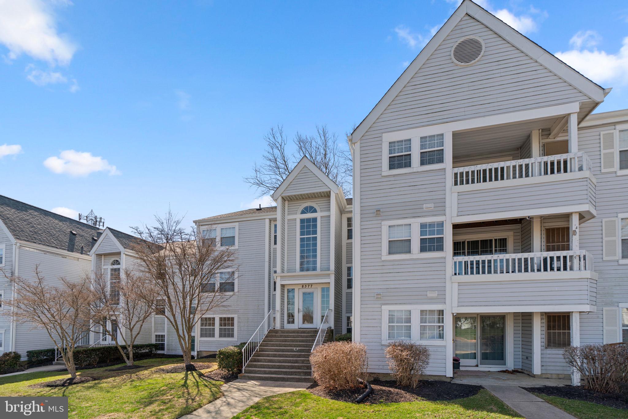 Charming condominium, meticulously maintained by the original owner, offering 1,084 square feet, 2 bedrooms, and 2 full bathrooms in desirable Montgomery Run. As you step inside, the foyer leads you into the spacious, open living area where gleaming and recently updated floors flow throughout. The inviting living room offers access to the private patio, and the adjacent sun-drenched dining room is the perfect spot for casual meals. Off the dining room, you'll find a bright galley kitchen with ample counter space, abundant cabinets, and a convenient stacked laundry area. This home offers two generously sized bedrooms, both featuring plush carpeting for added comfort. The primary suite includes double closets and an en-suite bath. The second bedroom boasts a walk-in closet and dual access to the hallway bathroom. Enjoy your morning coffee on the back patio while taking in the peaceful wooded views. The community offers a variety of amenities, including 1 assigned parking space, a pool, common grounds, scenic paths, tot lots, and a playground.