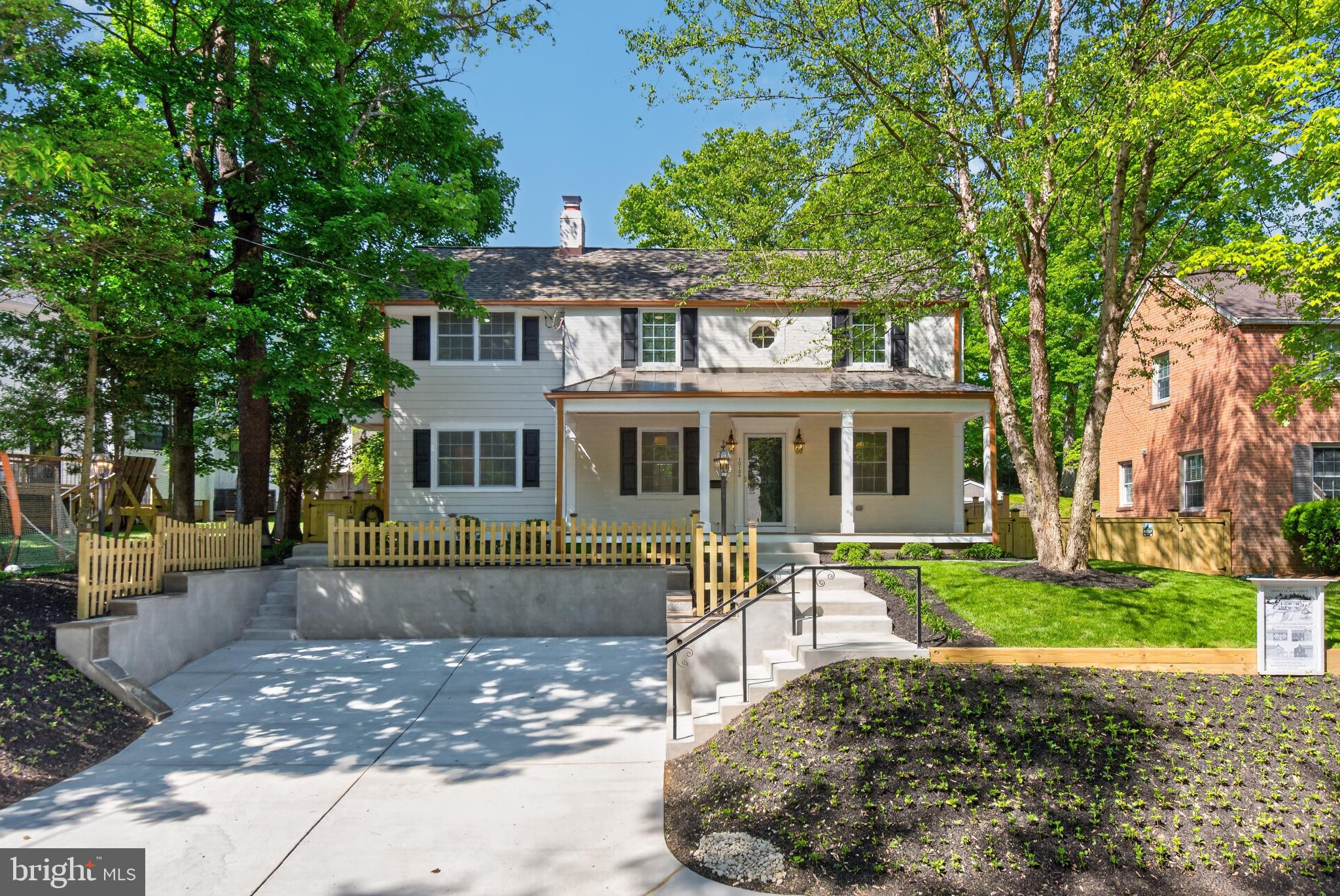 The city of Silver Spring has been recognized by Fortune Magazine as the #1 place to live in America! We are pleased to introduce a thoughtfully expanded and fully rebuilt luxury Colonial  set in one of the city’s most desirable neighborhoods, Woodmoor.  The Design Build Group, known locally for their quality craftsmanship and attention to detail  has delivered a architectural restoration of exceptional scale, finish, and livability—completely turnkey and designed for modern living. 
 
Nestled in a serene, tree-lined setting near protected parkland and forest trails, the property offers a rare blend of privacy, nature, and convenience. The exterior is entirely maintenance-free, with a timeless mix of brick, Hardie siding, metal accents, and thoughtfully designed outdoor spaces including classic covered porches and a private, fenced yard.  Inside, nearly 3,000 square feet of finished living space unfolds with a sense of openness and purpose. Sunlit living and dining areas are anchored by a gas fireplace and enhanced by custom millwork, while a wet bar with granite butler’s pantry creates an effortless flow for dining and entertaining.  A mudroom and powder lead to a gourmet kitchen featuring quartz countertops, generous cabinetry, a large peninsula and eat-in area designed for gathering.
Upstairs, four (4) well-proportioned bedrooms include a striking primary suite with cathedral ceilings, multiple closets, and a spa-inspired bath with marble vanities, soaking tub, and walk-in rain shower. A full laundry room with sink and additional full bath anchor a designer-lit hallway with closets, completing the upper level.
The finished lower level adds flexible living space with a large recreation area, kitchenette, and full bath—ideal for guests, entertaining, or extended stays—with direct access to the landscaped rear yard with a stand-alone workshop/shed. Every aspect of the home reflects careful planning and high-quality execution, from the systems and materials to the lighting and smart home features. The result is a pristine, move-in-ready residence offering comfort, efficiency, and enduring classical style.
All of this within the vibrant Woodmoor community, known for its strong neighborhood feel, tree-lined streets, nearby parks, and easy access to shopping, dining, and commuter routes—creating a lifestyle that is both connected and quietly refined.