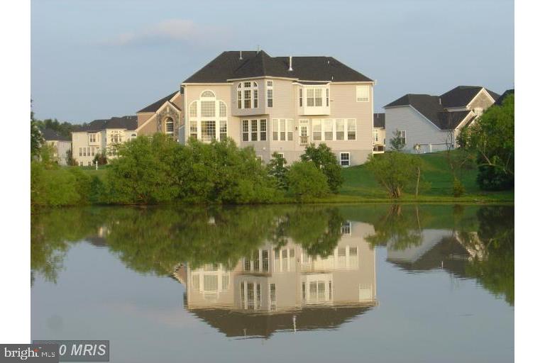 Gorgeous luxury home (half acre land) with beautiful back yard view of trees and a large pond. Open floor
plan. Stunning combination of stone and brick front boasting 3-car side load garage. Dramatic 2 story foyer
entrance & 2 story family room. Hardwood throughout main floor. Beautiful back yard view of trees and a
large pond. Walk-out basement. Nice community. Close to Rt 50 and Rt 28. *** 3 mins driving to LOUDOUN county TRANSIT BUS STOP  to Metro and DC!