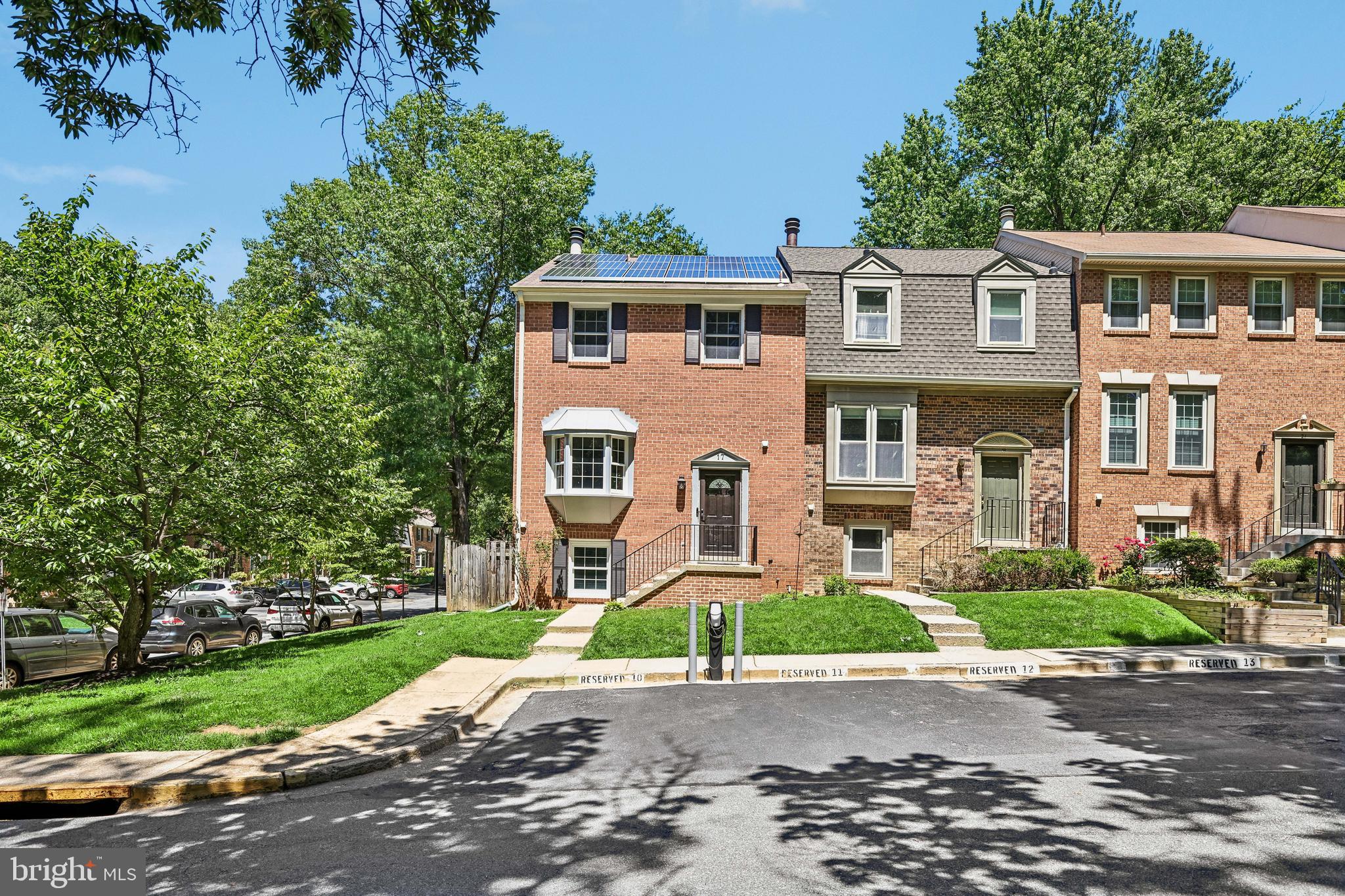 Rare, fully electric smart home in Shady Grove Village! This 2,231 sqft 3 bedroom and 3.5 bath end-unit townhome features a 6-zone built-in speaker system, Ecobee thermostat, Smart Locks, and solar panels. Enjoy two assigned parking spots right out front, complete with a dedicated EV charger. The open-concept main level shines with hardwood floors, a bay window, and a premium granite kitchen boasting island seating and top-tier Bosch stainless appliances. Dual en-suite bedrooms upstairs offer custom full-wall wardrobe cabinetry. The amazing walk-out lower level includes a spacious rec room, cozy fireplace, 3rd bedroom, and full bath. French doors lead to a huge, fenced stone patio with a convenient trash-service gate. Fully renovated down to the studs in 2007 (roof, HVAC, plumbing, wiring, 70+ recessed lights).  Just steps away from beautiful Malcolm King Park and  minutes to Downtown Crown, the new Wootton at Crown High School, Rio Lakefront, Shady Grove Metro, several bus lines, and I-270. Move-in ready-- this home has it all!  ***Offers Due Tuesday 9th at noon***  See Disclosures regarding 100% financing program.
