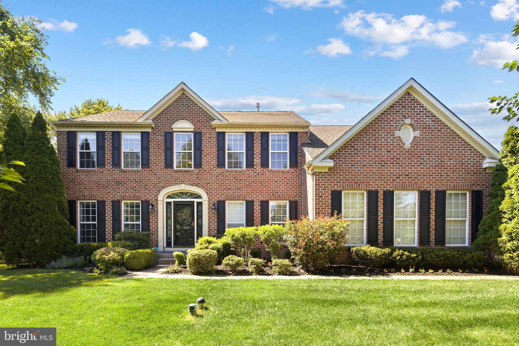 Welcome to this stunning home featuring an elegant center hall entrance highlighted by a sweeping curved staircase that sets the tone for the sophistication found throughout. To the right of the foyer, French doors open to a beautifully appointed office, providing the perfect work-from-home space. The formal living room offers a welcoming place to relax and flows seamlessly into the formal dining room, creating an ideal setting for entertaining. Beautiful hardwood floors, custom moldings, and plantation shutters enhance the home's timeless appeal. The heart of the home is the spacious open-concept eat-in-kitchen, designed to impress with abundant tall cabinetry, a pantry, granite countertops, a center island with wine cooler, glass-front refrigerator electric range with air fryer and convection oven, and a built-in microwave, stainless steel refrigerator. Adjacent to the kitchen, the inviting family room features a cozy wood-burning fireplace, while a convenient powder room completes the main level. Step outside from the kitchen to an expansive deck with a gazebo, overlooking the professionally landscaped .63-acre property. The backyard offers plenty of space for outdoor enjoyment and includes a children's playset and a versatile outbuilding perfect for a future man cave, she shed, hobby space or additional storage. The first floor also includes a utility room with washer and dryer and direct access to the attached two-car garage with electric door openers. The finished basement adds exceptional living space and includes a full bathroom, offering endless possibilities for an in-law suite, teen retreat, recreation room, home gym, billiards room, or entertaining area. Upstairs you'll find 4 generously sized bedrooms, including an impressive primary suite featuring a spacious sitting room, two walk-in closets, tray ceiling, and a luxurious ensuite bath with a soaking tub, separate shower, dual vanities, and beautiful cabinetry. Three additional bedrooms and a full hall bath complete the second level. Additional features include two-zoned heating and cooling. A prime location convenient to I-95 and Route 1, providing easy access to Philadelphia, Trenton/Hamilton train station, New York City, and the Jersey shore. This exceptional home combines elegance, comfort, and convenience. Schedule your private tour today before this incredible opportunity is gone! Floor plans at end of pictures