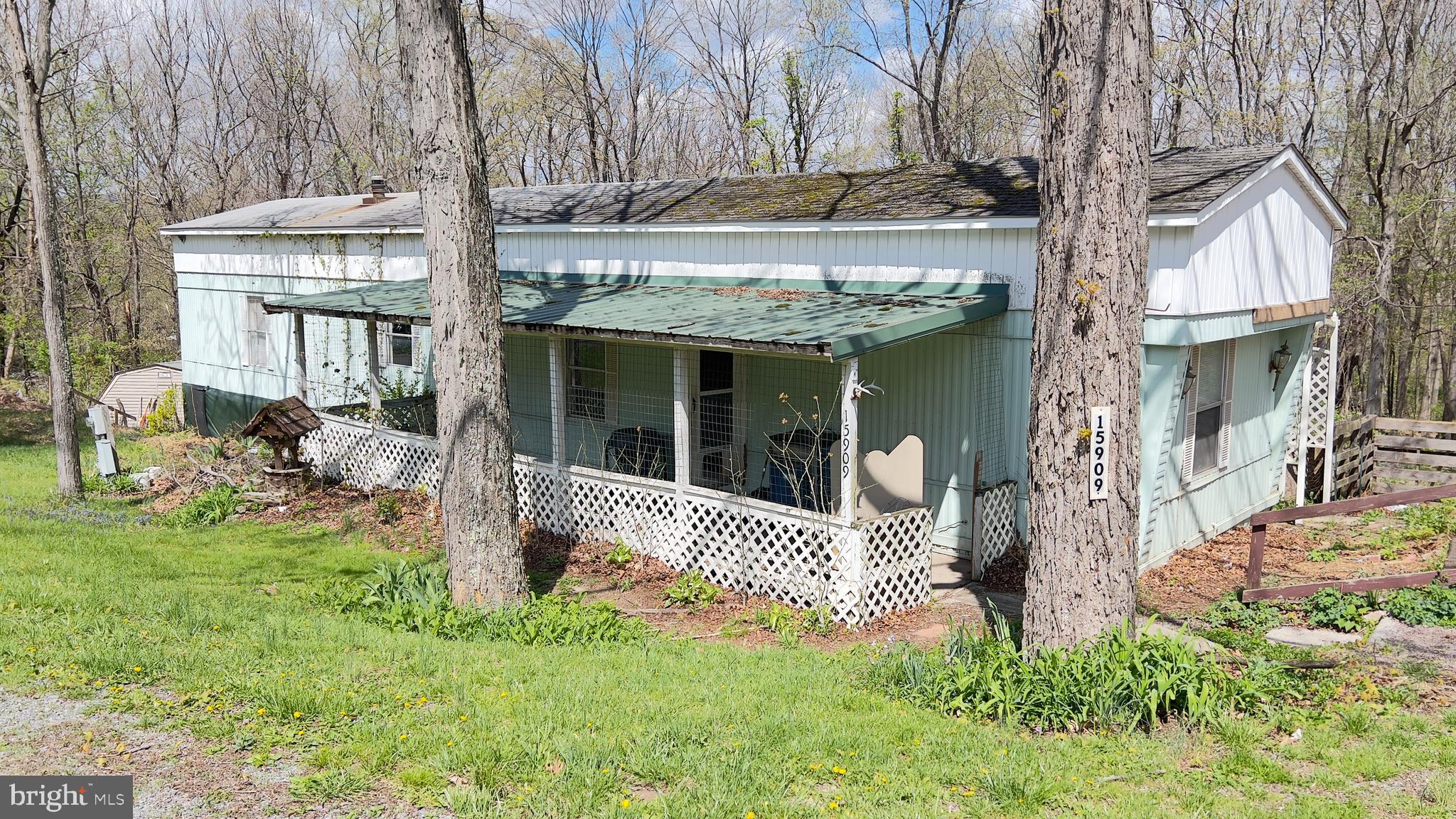 PRICED TO SELL.  This mobile home situated on a RENTED LOT (No real property conveys).  Features 2 bedrooms and 2 baths, covered front porch area.  The roof is a PITCHED shingle roof.  There is a small addition on the back for storage.  Previous owner had a wood stove there not sure of condition.  This one is priced to sell.  Mobile can not be moved from the lot per the seller.  Current lot rent is $425.00 per month plus $100 for water, sewer and trash pickup.  This is not a rent to own or owner finance.  Most likely cash will be needed to purchase.
