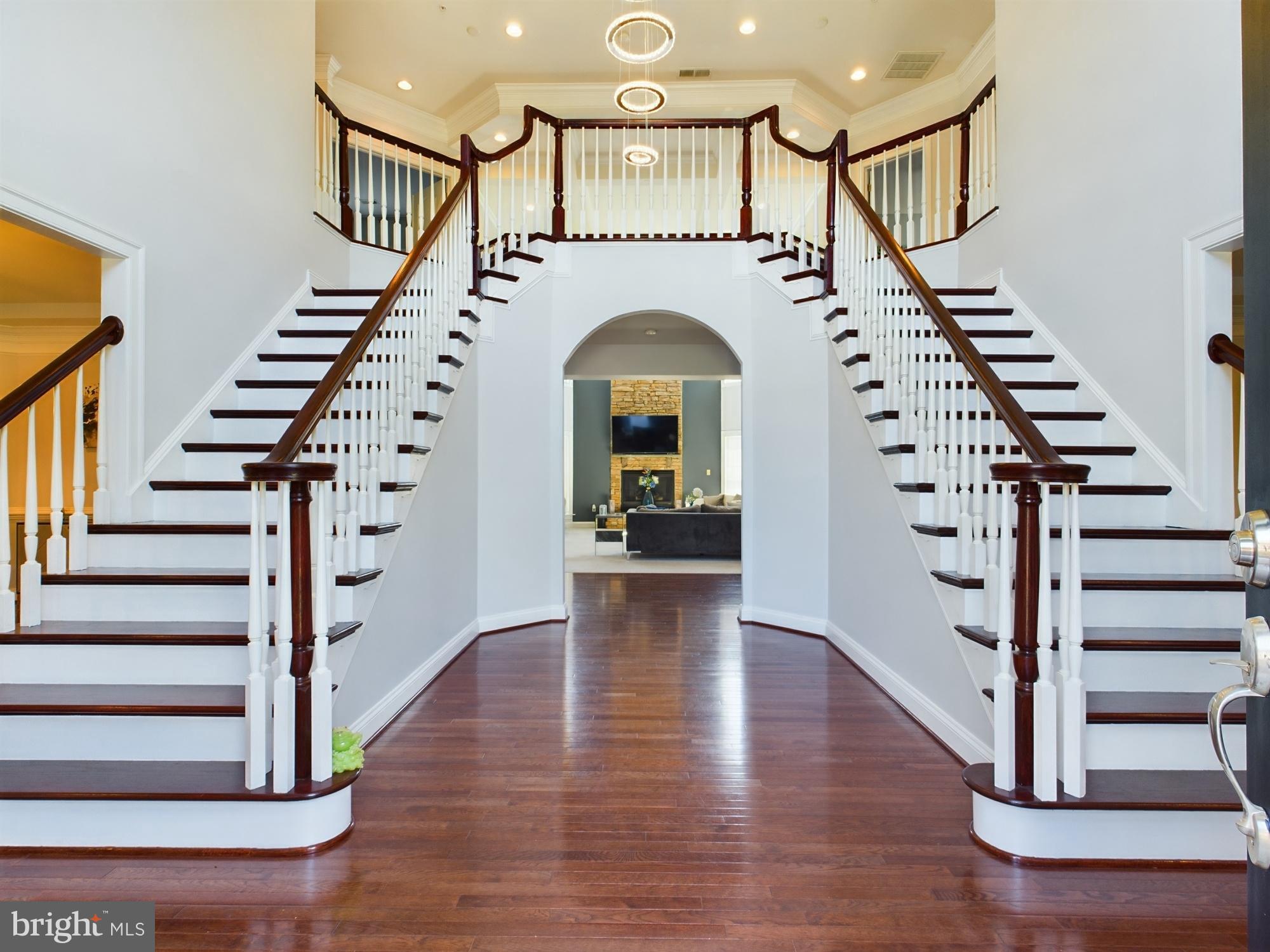 Welcome to 14601 Driftwood—a statement residence in Bowie offering elevated design, exceptional space, and true multi-level luxury living. From the moment you enter, you’ll feel the difference: a grand dual staircase, an airy two-level living room filled with natural light, and refined entertaining spaces that flow effortlessly from the formal dining room into an elegant sitting area highlighted by a striking custom designer feature wall.

The heart of the home is the chef-inspired gourmet kitchen, perfectly paired with a butler’s pantry for seamless hosting and extra storage. The main level also features a private office with a full en-suite bath—ideal for working from home or accommodating guests—plus a convenient laundry room and stylish powder room.

Upstairs, the home continues to impress with a second-floor family room overlook—a flexible, light-filled space perfect for a lounge, homework hub, or additional media area while staying connected to the open living room below. The second level offers three generously sized bedrooms, each with its own private bath and walk-in closet for comfort and privacy. The primary suite is a true retreat with a private sitting area, built-in bar, a spa-caliber bath, and an expansive walk-in closet designed for serious wardrobe goals. A second upper-level laundry room adds everyday ease.

The fully finished lower level is the showstopper—your private resort-style retreat complete with a full gourmet kitchen, a spa-inspired luxury bath, and two additional bedrooms—perfect for extended family, guests, or private quarters. Enjoy movie nights in the dedicated home theater, stay on routine in the private gym, and entertain in style in a space that blends comfort, functionality, and sophistication.

Outside, enjoy a large backyard ready for gatherings, play, or peaceful evenings. Add in a 3-car garage, a roof approximately 1 year old, and the rare bonus of NO utility fee (paid in full)—and you have a home that delivers luxury without compromise. Schedule your private tour today.