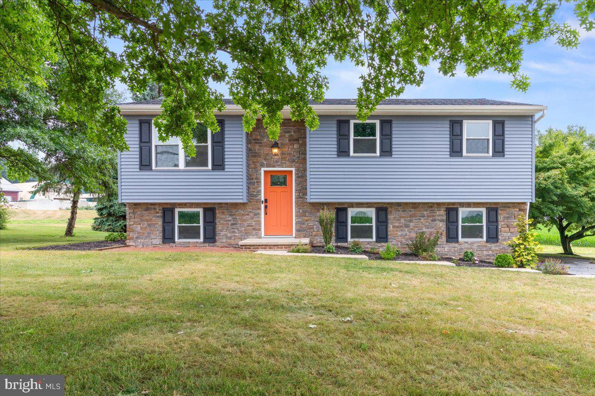Perched atop a scenic hill just outside Manheim, this beautifully renovated bi-level home in Rapho Township offers breathtaking panoramic views across Northern Lancaster County. Situated on a 0.85-acre lot in Manheim Central School District, this move-in ready 3-bedroom, 2-bath home combines peaceful country living with convenient access to shopping, dining, and major commuter routes.
 
The show-stopping kitchen is the heart of the home, featuring granite countertops, soft-close cabinetry with pull-out drawers and a Lazy Susan, a deep farmhouse sink, updated stainless steel appliances, a propane gas range, and an oversized center island perfect for gathering. The open-concept living/dining/kitchen layout flows seamlessly onto the newly rebuilt two-tier deck, creating the ideal space for entertaining while taking in spectacular Lancaster County farmland views.
 
Step outside to enjoy everything this exceptional property has to offer: from the tranquil koi pond and expansive rear deck overlooking the rolling countryside to the charming front brick patio with mature trees and impressive driveway for your guests. Whether you're enjoying your morning coffee or hosting family and friends, the outdoor spaces are every bit as impressive as the interior.
 
The main level was extensively renovated in 2024 and showcases high-end luxury vinyl plank flooring throughout along with an updated full bathroom. The finished lower level provides flexible living space for a family room, home office, gym, or recreation area, along with a second full bath and a hearth/flue ready for the next owner to install the stove of their choice. A two-car attached garage offers additional storage and everyday convenience.
 
Buy with confidence knowing nearly every major component has been updated in 2024, including the roof, HVAC system, water heater, water treatment system, windows, exterior doors, flooring, and energy-efficient appliances. Your peace of mind is also front and center with keypad locks on the main entrances, a hardwired Ring doorbell camera, and hard-wired smoke and CO monitors. If you've been searching for an updated home for sale near Manheim with modern finishes, a finished basement, incredible outdoor living, and unforgettable country views, this one-of-a-kind Lancaster County property is ready to welcome you home.