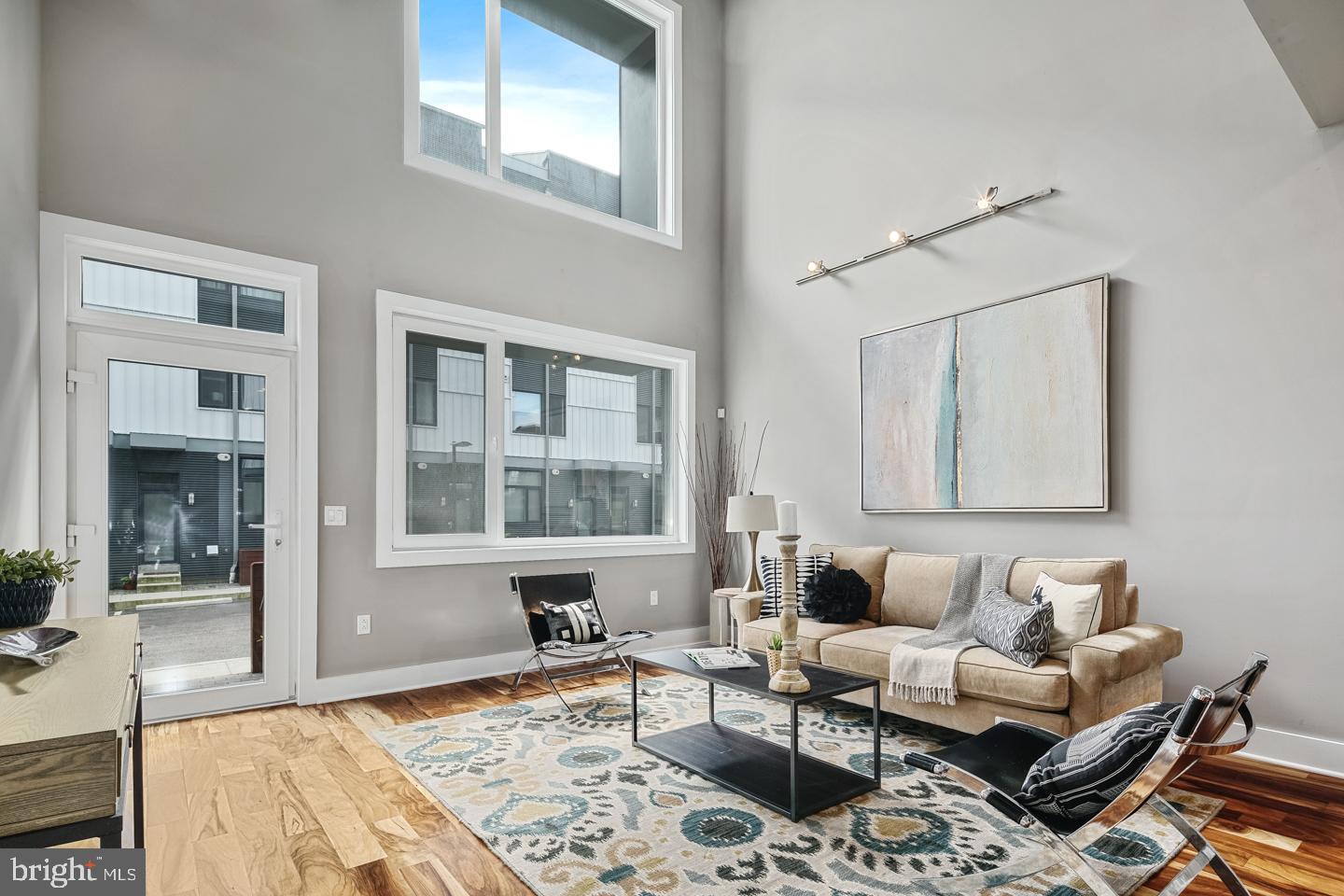 Welcome to The Stables Development: a stunning collection of thoughtfully crafted homes in the heart of Northern Liberties. This spacious 3 bedroom, 3 full / 2 half bathroom END UNIT residence features soaring 20-foot ceilings in the living room, 2 car assigned parking, and a private roof deck offering sweeping views. The kitchen is a chef’s dream, equipped with stainless steel appliances, an induction cooktop, wine cooler, quartz countertops, a stylish tiled backsplash, and ample cabinetry. Each bathroom is beautifully finished with floating vanities, glass-enclosed showers, and designer tile work. Enjoy wide plank hardwood flooring throughout, custom iron railings, and walk-in closets with built-in shelving. The finished basement provides additional living space, while the private front yard with fencing adds a rare touch of outdoor comfort. Situated in one of Philadelphia’s most desirable neighborhoods, this home offers unbeatable access to everything Northern Liberties has to offer. Known for its creative energy, thriving food scene, and walkable streets, Northern Liberties is home to a mix of trend-setting restaurants, coffee shops, and locally owned boutiques. Spend your weekends at Liberty Lands Park, take your pup to Orianna Hill Dog Park, or stroll through Liberties Walk and The Piazza for open-air dining and shopping. Convenient access to the Market-Frankford Line makes commuting a breeze, and nearby grocery stores and fitness studios add to everyday ease. Don’t miss your opportunity to own a modern home with timeless design in one of Philadelphia’s most vibrant and fast-growing communities! Taxes and square footage is the responsibility of the buyer to have verified independently. *Interior photos are of a similar home in the development and may not portray actual finishes.