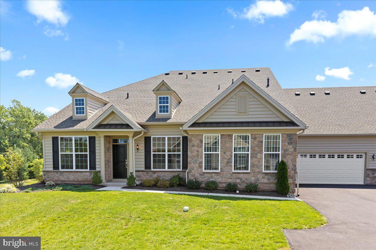 Welcome to an exquisite Toll Brothers home nestled in the heart of the vibrant Regency at Hilltown 55+ community, meticulously crafted in 2021 for the epitome of modern upscale living. The exterior, adorned with stone and high-end vinyl siding, showcases what to expect on the inside of this luxurious gem. This home features two massive bedrooms and two and a half large bathrooms. Please take note of the both rare and desirable rear facing lot with one of the best views in the entire community! This practically new residence boasts a thoughtful design, emphasizing main-level living with a seamless open-concept floor plan, providing an ideal blend of functionality and luxury. As you enter, be captivated by the radiant ambiance created by recessed lighting, highlighting the elegant features throughout. The expansive windows frame a picturesque countryside view, inviting the beauty of nature into your daily life. The gourmet kitchen stands as the heart of this home, featuring granite countertops, a pearlescent backsplash, and gas cooking. It’s a culinary haven that seamlessly blends style and functionality. The family room is complimented by exquisite board and batten trim work, creating a timeless facade that combines durability and aesthetic appeal. Inside, the home features vaulted ceilings and maple hardwood flooring, lending an air of sophistication to every room. At the heart of the den we have a gas fireplace to create a cozy atmosphere complimented by an amazing view on either side through the massive windows. A brilliant study with a scenic view also occupies the main level. The oversized 2-car garage adds practicality to the luxurious living experience. Escape to the tranquility of the back patio, a private oasis perfect for relaxation or entertaining. The large primary bedroom is a retreat in itself, flooded with natural light through numerous windows, complemented by his and her walk-in closets. The attached primary bathroom features a double vanity, a soaking tub, and a frameless glass shower, embodying a spa-like experience within the comforts of home. Ascend to the second floor to discover a loft area and an additional bedroom, providing flexibility for various living arrangements. The home is not just a residence; it’s a testament to a lifestyle curated for comfort, style, and convenience. Beyond the confines of this elegant abode, the community beckons with a massive clubhouse, offering endless activities, a fitness center, and a refreshing pool. Embrace a social and active lifestyle, surrounded by like-minded individuals in this exclusive 55+ community. Indulge in the pinnacle of contemporary living within the timeless elegance of this Toll Brothers home—a place where luxury, comfort, and community converge seamlessly. Welcome home to a life of serenity and sophistication. Make an appointment today because this home will not last long!