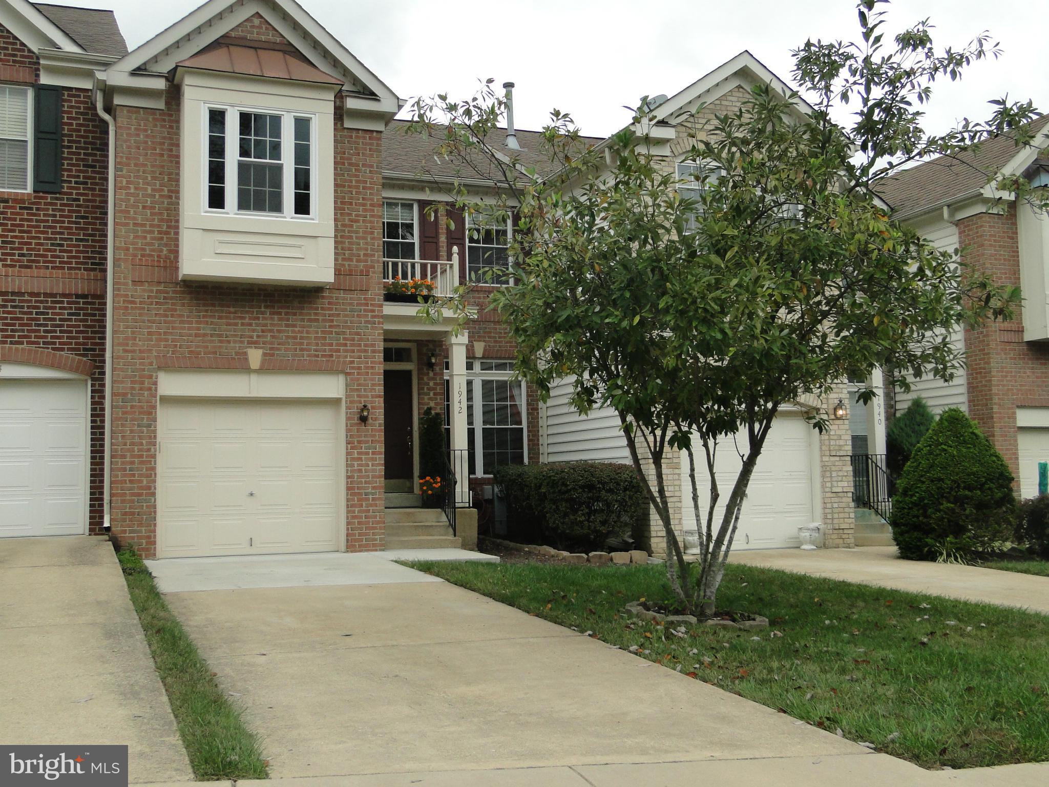 Move-in Picture Perfect Interior Town Home in Woodmore South. Airy  & light this home features floor to ceiling windows, ceiling fans, granite counter tops, bumps outs on all three levels, finished lower level w/office, recreation room & walk-up.Amazing main level w/hardwood flooring, 18" ceramic tiled floor in kitchen & breakfast room, gas fireplace in delightful family room.THIS ONE WILL GO FAST